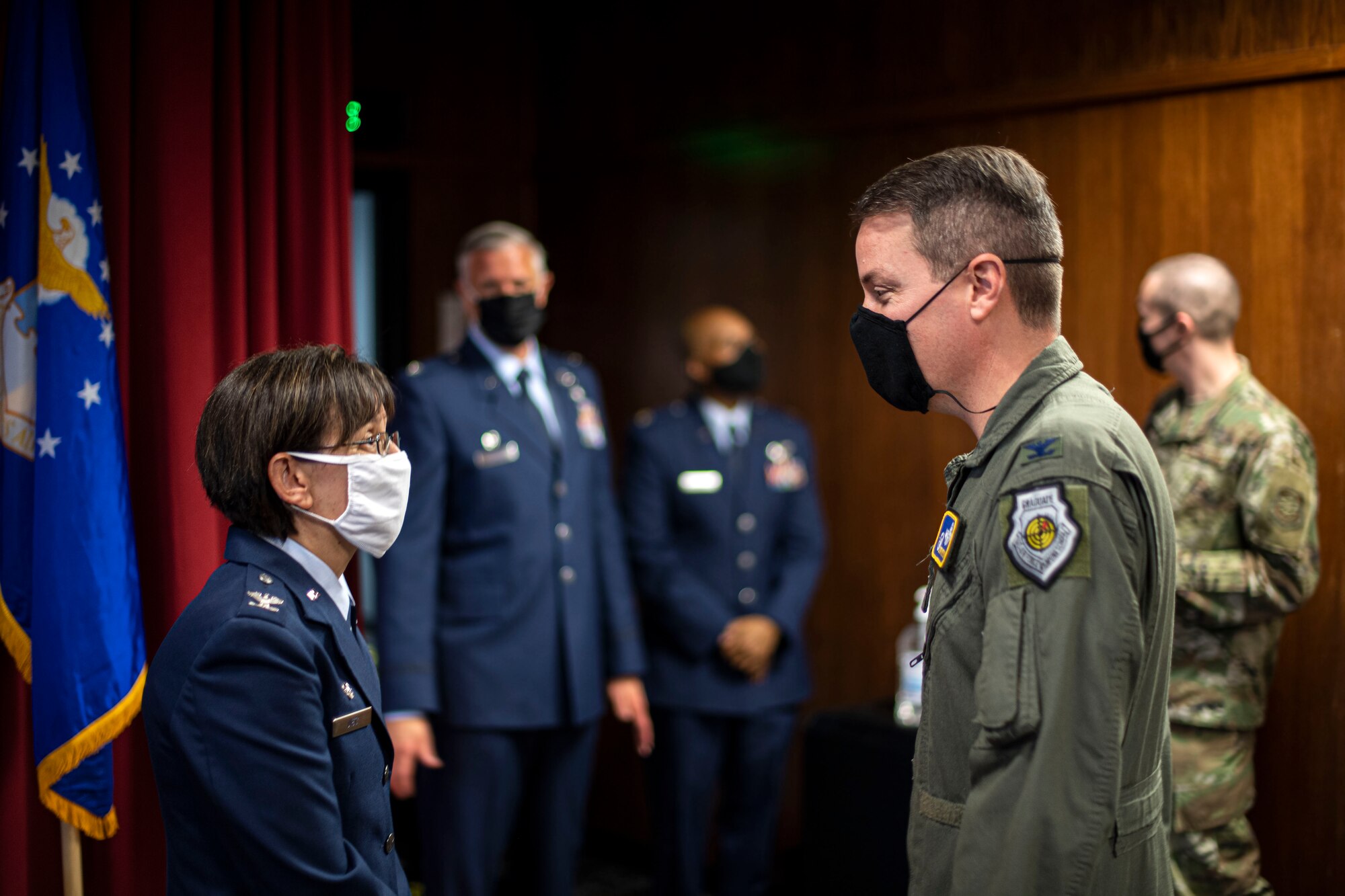 U.S. Air Force Col. Suzie Dietz, 60th Aeromedical Evacuation Squadron commander, speaks with Col. Jeffrey Nelson, 60th Air Mobility Wing commander, following an assumption of command ceremony June 9, 2020, at Travis Air Force Base, California. Dietz was formerly the 99th Inpatient Operations Squadron commander at Nellis AFB, Nevada. (U.S. Air Force photo by Senior Airman Christian Conrad)