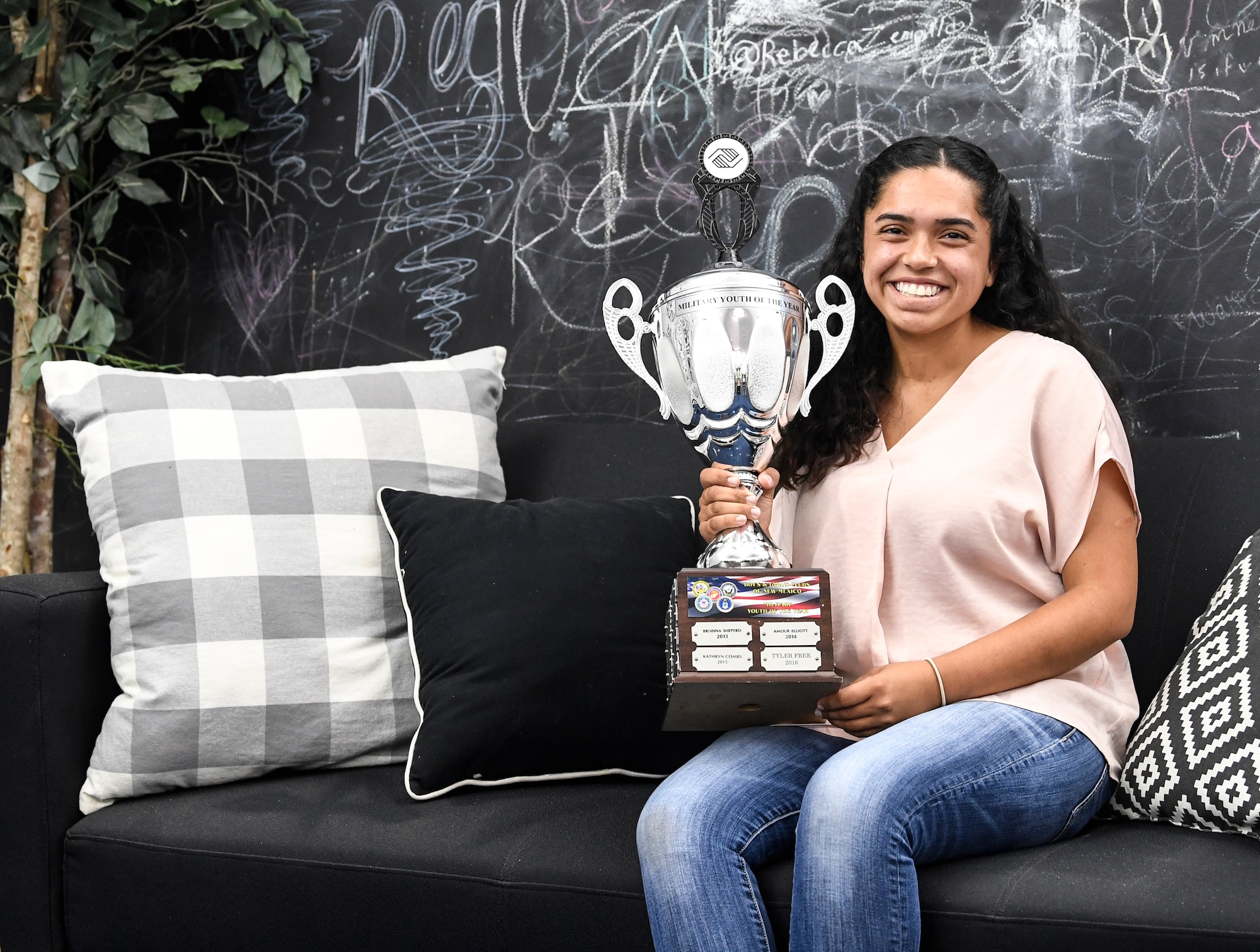 A girl holds her trophy.