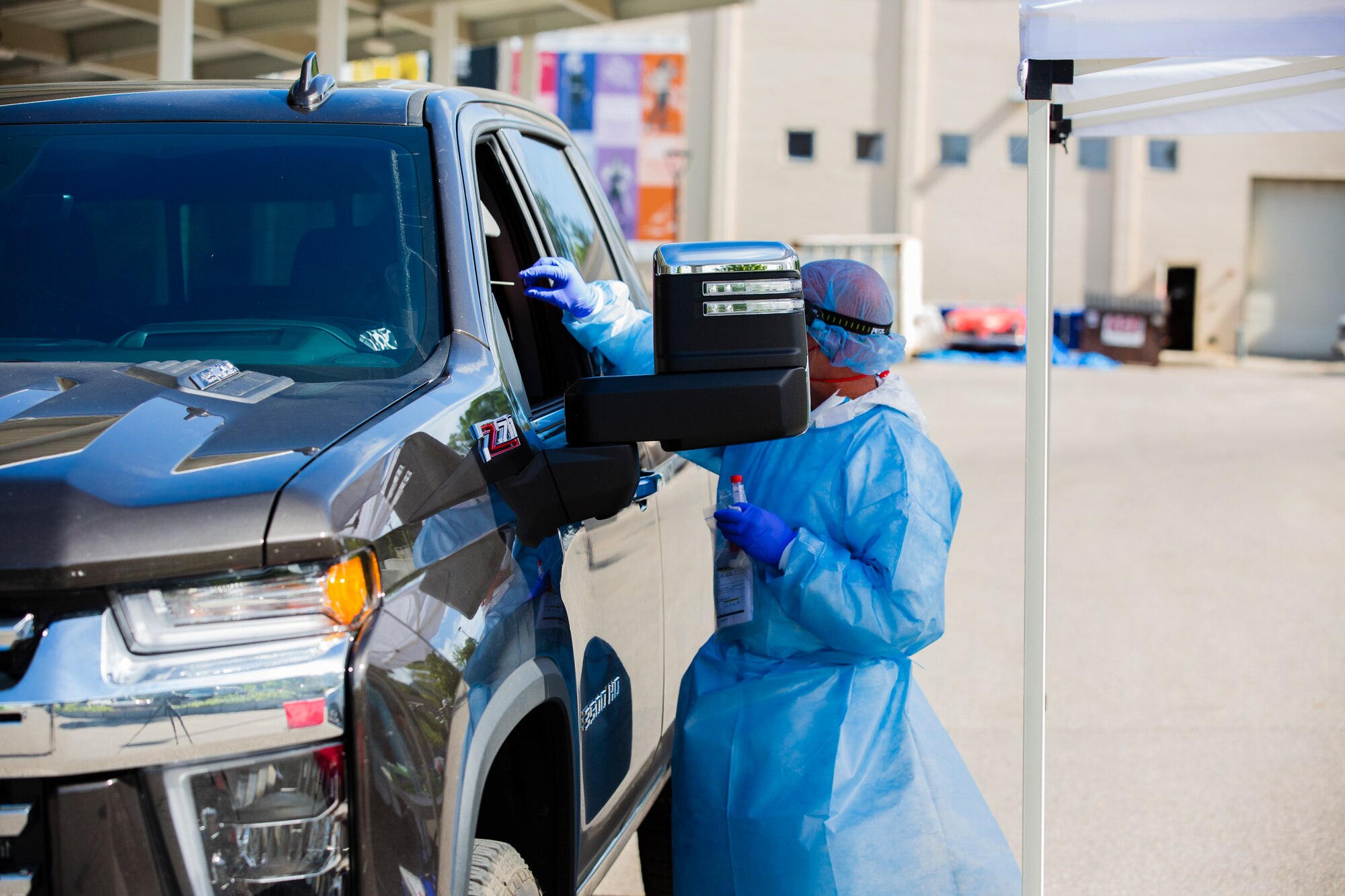 Mobile Testing Team member conducts a nasopharyngeal sample collection on an individual in Salt Lake City to check if they are a carrier of the novel coronavirus, COVID-19, May 27, 2020. To collect a sample a flocked swab is sent through the nasal cavity and will stay there for 20 seconds, be twisted and removed.