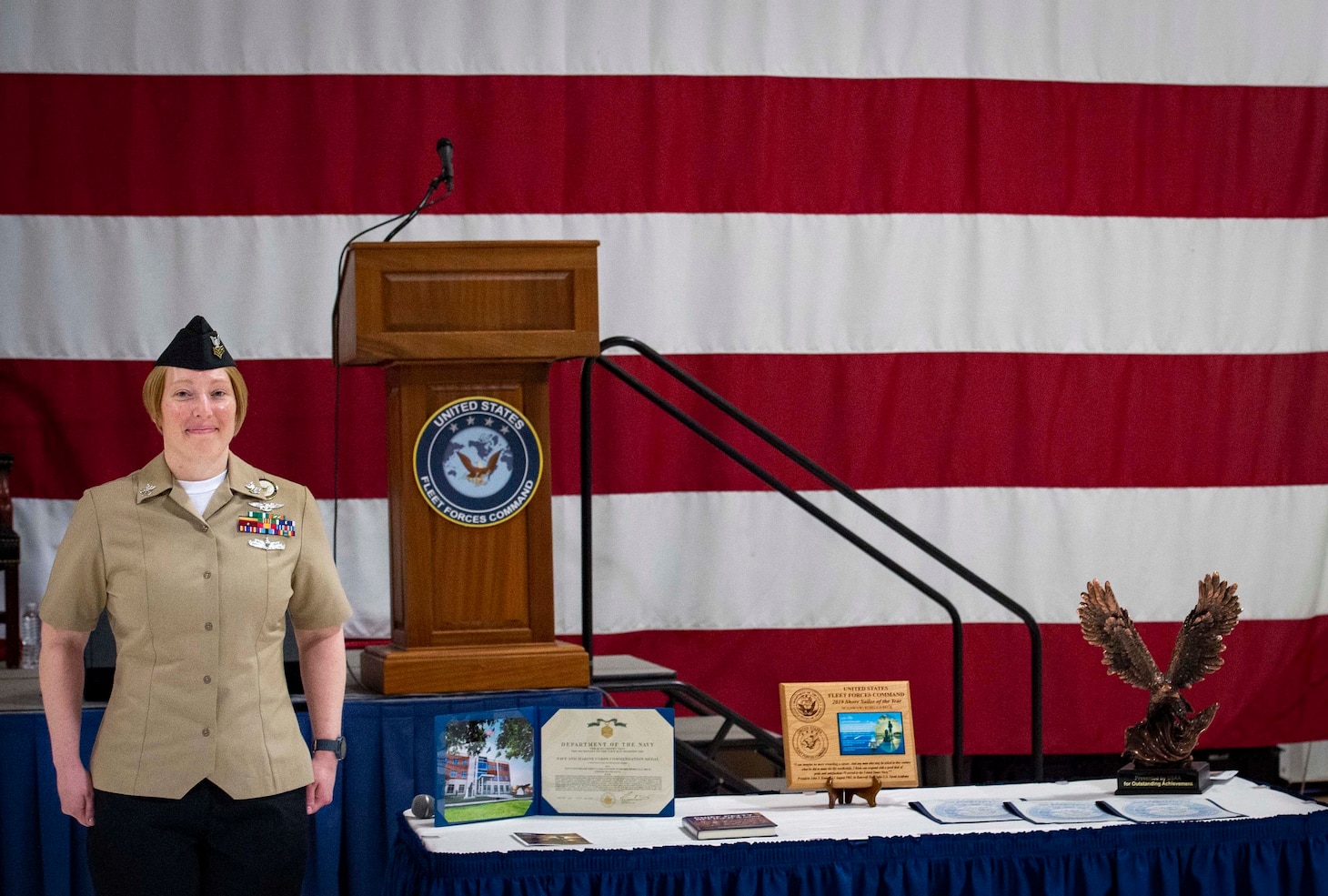 Shore Sailor of the Year (SOY) Navy Counselor 1st Class Rebecca Beck, of Strike Fighter Squadron (VFA) 106 and a native of Maryville, Tennessee, is presented with a Navy Commendation Medal during the 2019 USFF SOY ceremony at the Center for Naval Aviation Technical Training hangar onboard Naval Air Station Oceana.