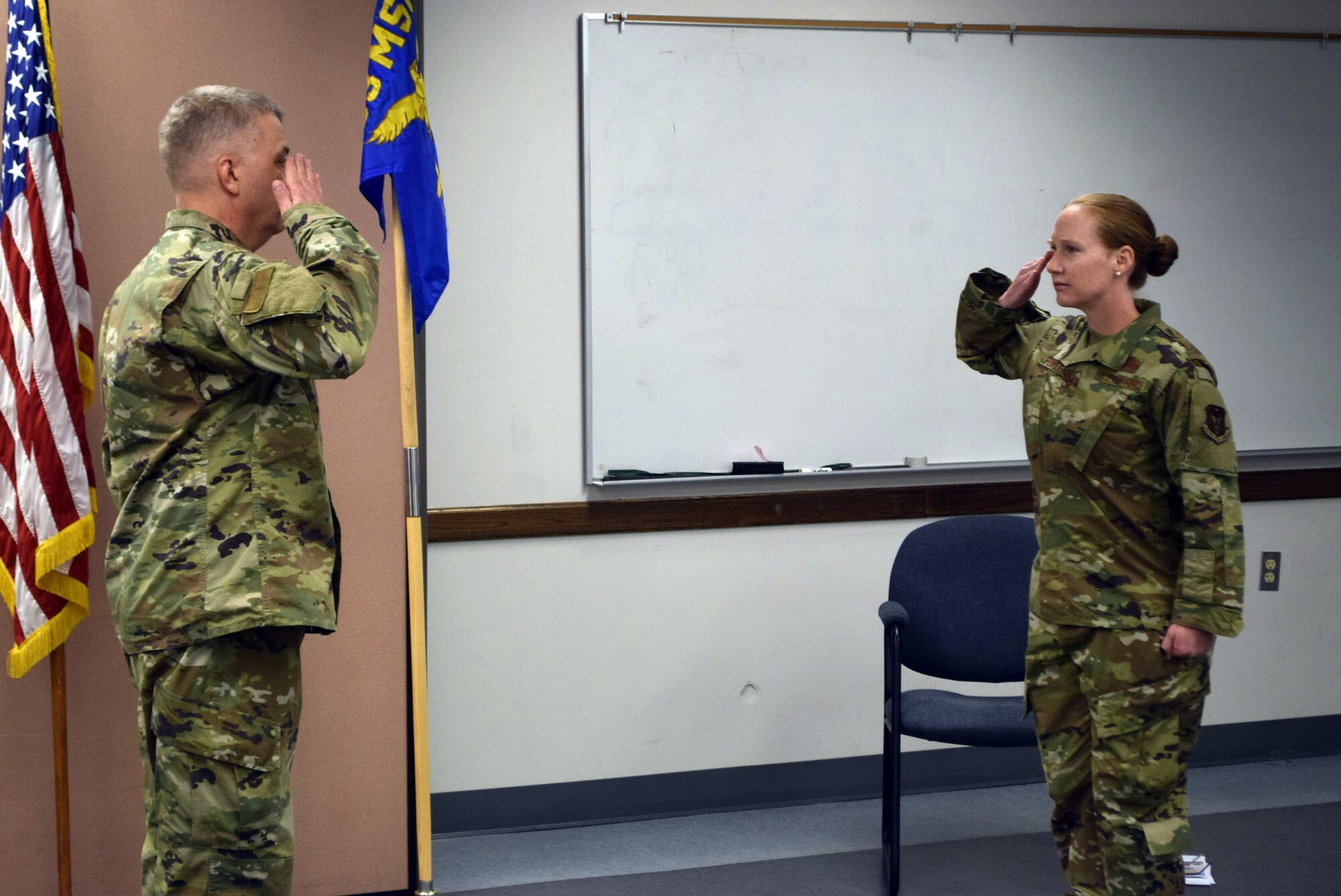 Maj. Kristen B. Fowler, 74th Aerial Port Squadron commander (right), salutes Col. Wayne M. Williams, 433rd Mission Support Group commander, during a change of command ceremony at Joint Base San Antonio-Lackland, Texas, June 6, 2020.