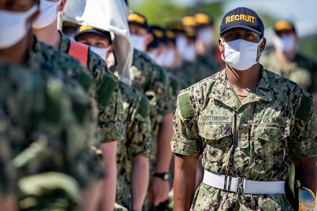 Navy recruits march in formation.