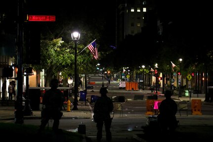 Soldiers from the North Carolina Army National Guard 105th Military Police Battalion stand guard in downtown Raleigh, May 31, 2020. Approximately 450 Guardsmen have been mobilized due to civil unrest.  The Guard will support local authorities and help safeguard the lives and property of North Carolinians and the ability for individuals to exercise their rights to peaceful protest.