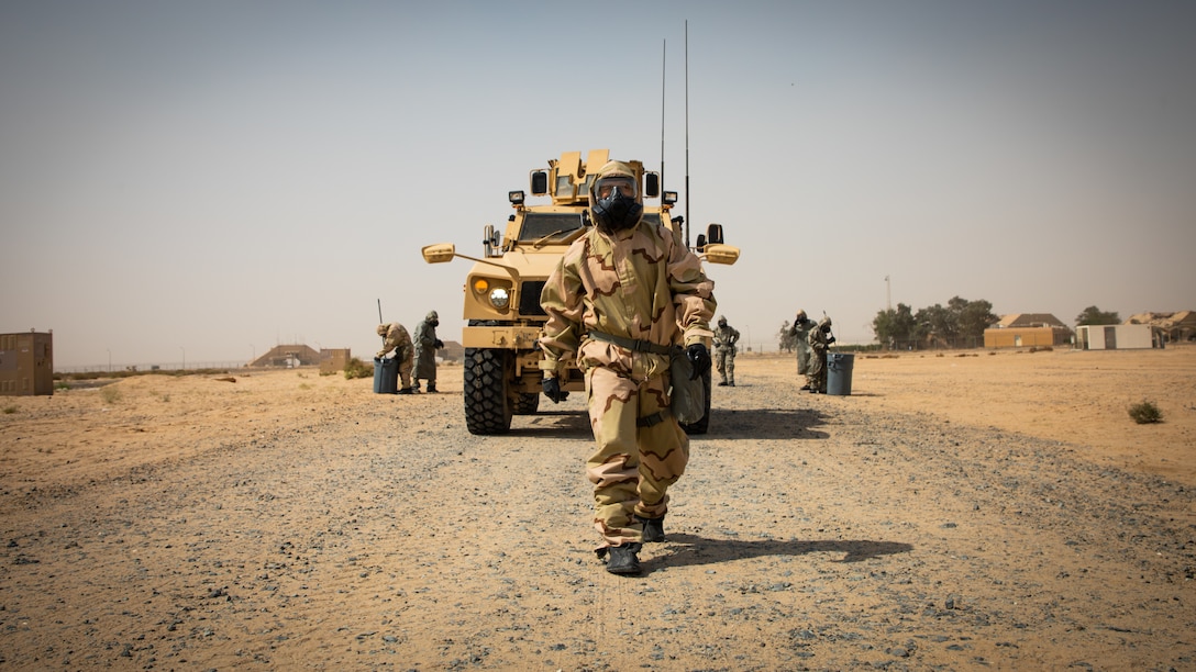 A U.S. Marine ground guides a Mine Resistant Ambush Protected All-Terrain Vehicle during a Reconnaissance, Surveillance, and Decontamination Training Course in Kuwait, April 22.