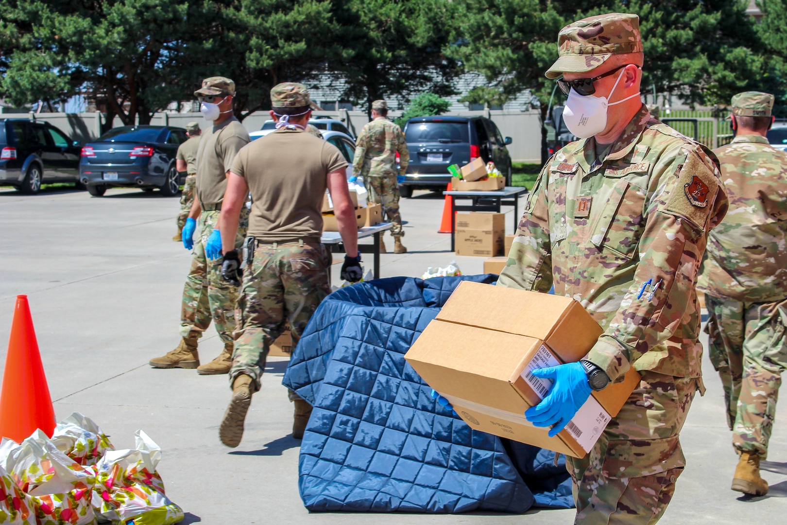 Capt. Michael Zimmer, a chaplain with the Nebraska Air National Guard, helps distribute food to families in need during a Food Bank of Lincoln mobile pantry event, June 3, 2020, in Waverly, Nebraska. As the chaplain for the Joint Task Force Nebraska National Guard COVID-19 mission, Zimmer speaks with troops to check on their mental and spiritual welfare.