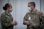 U.S. Air Force Col. Yvonne Mays, left, director of staff, New Jersey Air National Guard, speaks with Maj. Justin Krowicki, with the New Jersey Air National Guard’s 177th Fighter Wing, at the Federal Medical Station inside the Atlantic City Convention Center, Atlantic City, N.J., April 24, 2020.