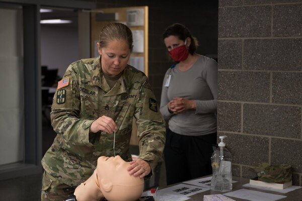 Staff Sgt. Jessica DeZelar, a combat medic with 204th Medical Company Area Support, trains to administer a swab test for COVID-19 May 14 in St. Paul.