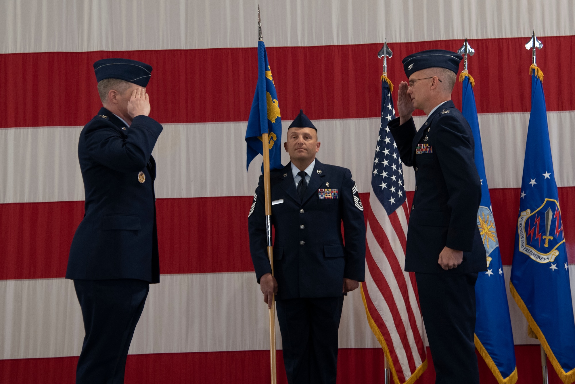 PETERSON AIR FORCE BASE, Colo. – Col. Patrick Pohle (right) salutes Col. Sam Johnson, 21st Space Wing commander, to assume command of the 21st Medical Group on June 9, 2020 at Peterson Air Force Base, Colorado. The tradition of the passing of the unit guidon did not occur in order to maintain proper physical distancing guidelines due to COVID-19. (U.S. Air Force photo by Staff Sgt. Alexandra M. Longfellow)