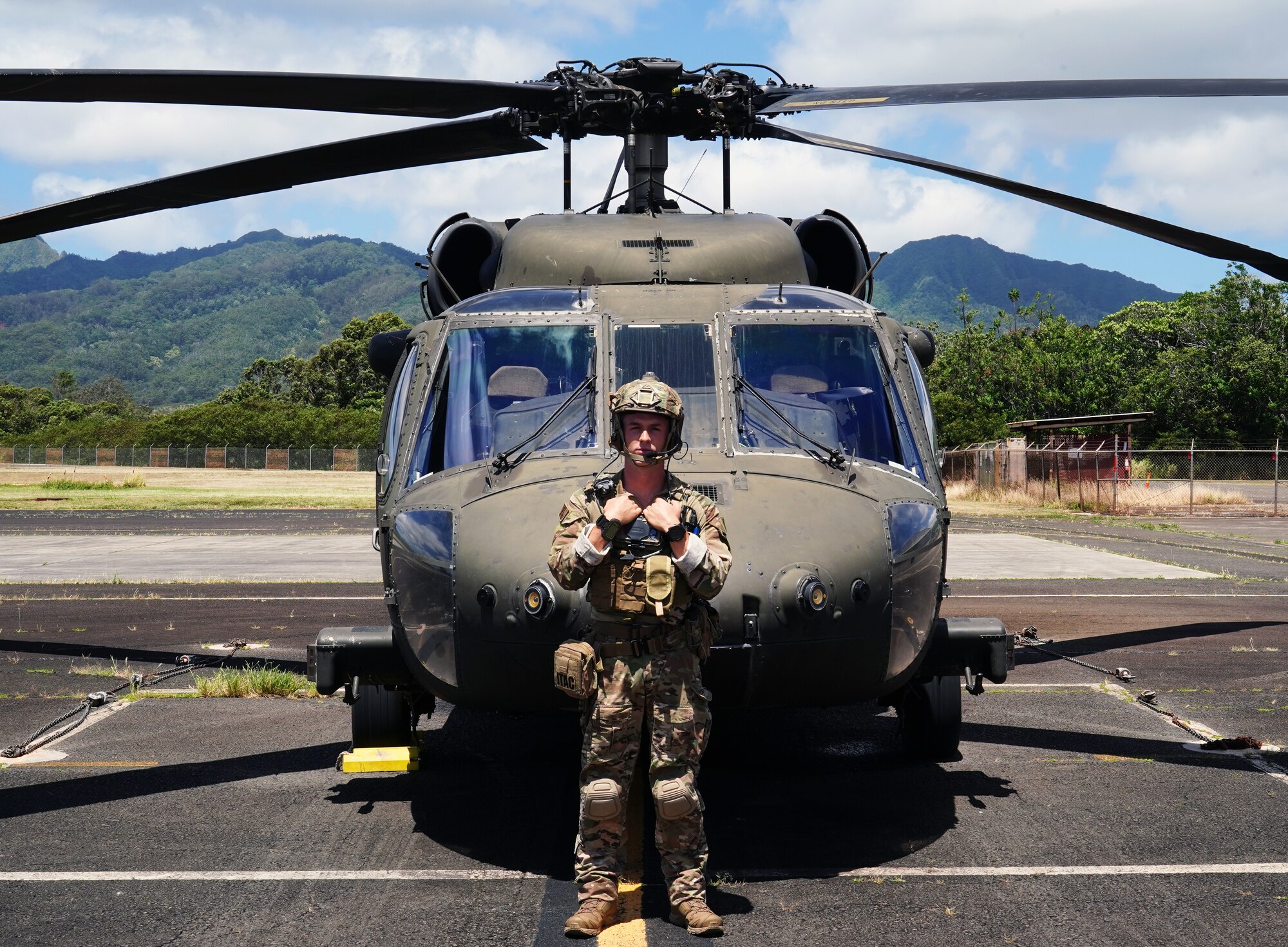 U.S. Air Force Staff Sgt. Derek Skelton, 25th Air Support Operations Squadron Tactical Air Control Party Airman, stands in front of a Sikorsky UH-60 Black Hawk on Wheeler Army Airfield, Hawaii, June 5, 2020. TACP Airmen train while down range and on simulations to ensure they are always battle-ready. (U.S. Air Force photo by Airman 1st Class Erin Baxter)