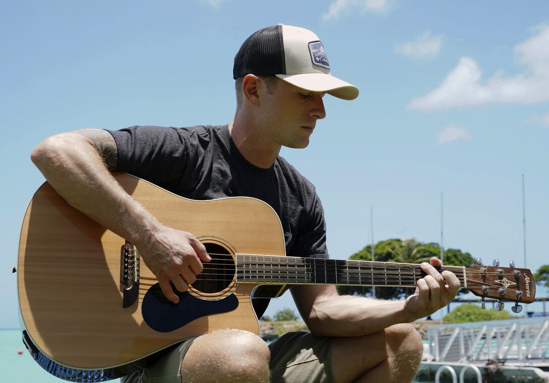 U.S. Air Force Staff Sgt. Derek Skelton, 25th Air Support Operations Squadron Tactical Air Control Party Airman, sits by the beach on Joint Base Pearl Harbor-Hickam, Hawaii, June 5, 2020. The job of a TACP Airman is to ensure airstrikes hit the right target downrange. (U.S. Air Force photo by Airman 1st Class Erin Baxter)