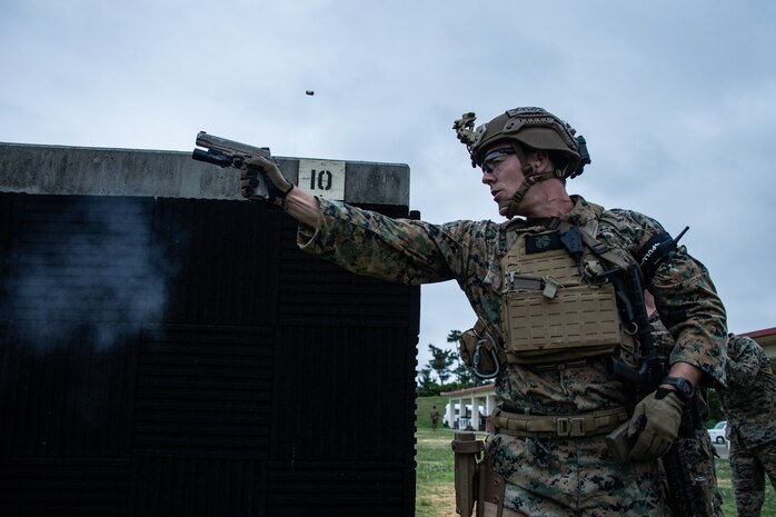 A special amphibious reconnaissance corpsman fires his M45A1 service pistol during a stress shoot as part of a close-quarters tactics range on Camp Hansen, Japan May 14.