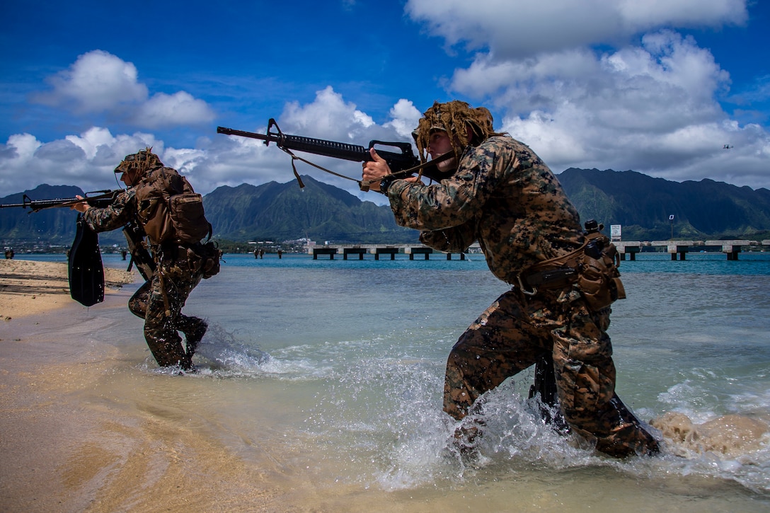 U.S. Marines with Lima Company, 3rd Battalion, 3d Marine Regiment, traverse through water during an amphibious assault exercise, Marine Corps Base Hawaii, May 28, 2020. Bravo Company, 1st Battalion, 3d Marine Regiment, and Lima Company, 3rd Battalion, 3d Marine Regiment, conducted an amphibious assault exercise and military operations in urban terrain to increase littoral mobility proficiency in 3d Marine Regiment and advance the goals of the Commandant of the Marine Corps 2030 Force Design.