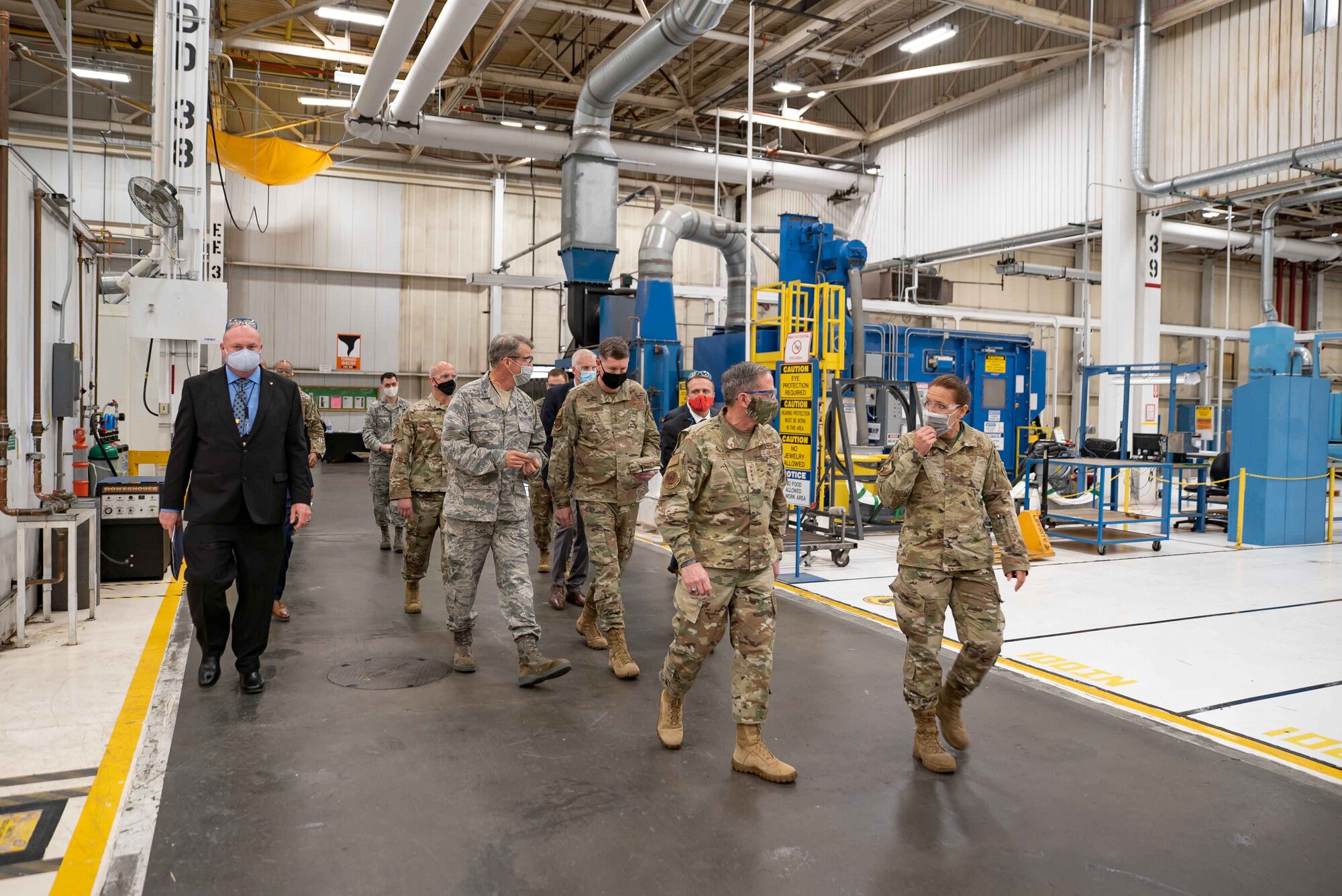 photo of distinguished visitors walking through a hall