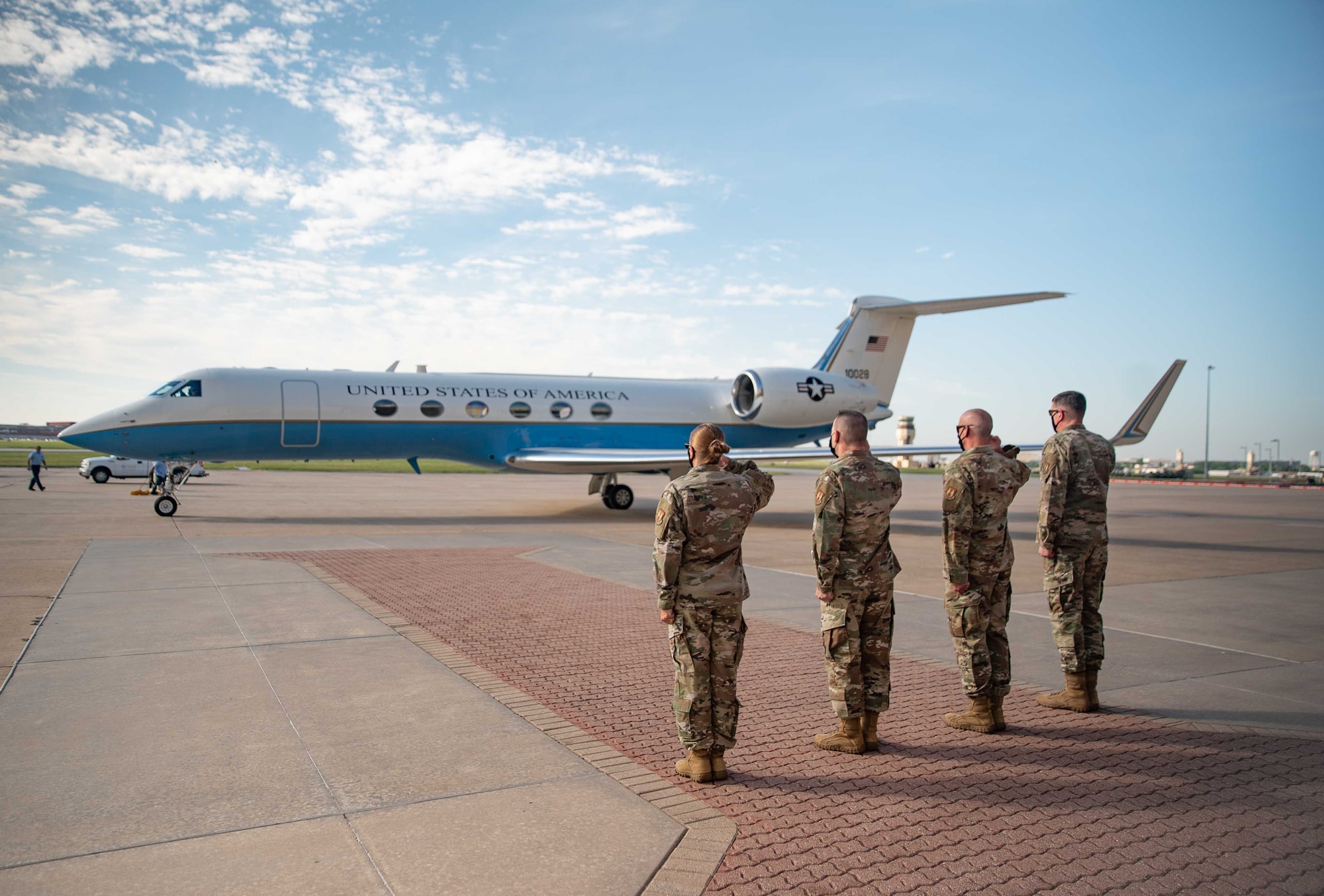 senior leaders welcome arriving plane