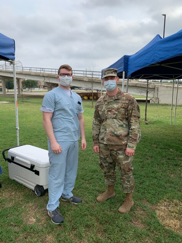 Lab assistants from Wilford Hall Medical Center at Lackland Air Force Base, Texas, assist with receiving specimens at Lackland’s flight line, May 20, 2020. The specimens were collected from deployers at Cannon Air Force Base, New Mexico, to test for COVID-19. (Courtesy Photo)