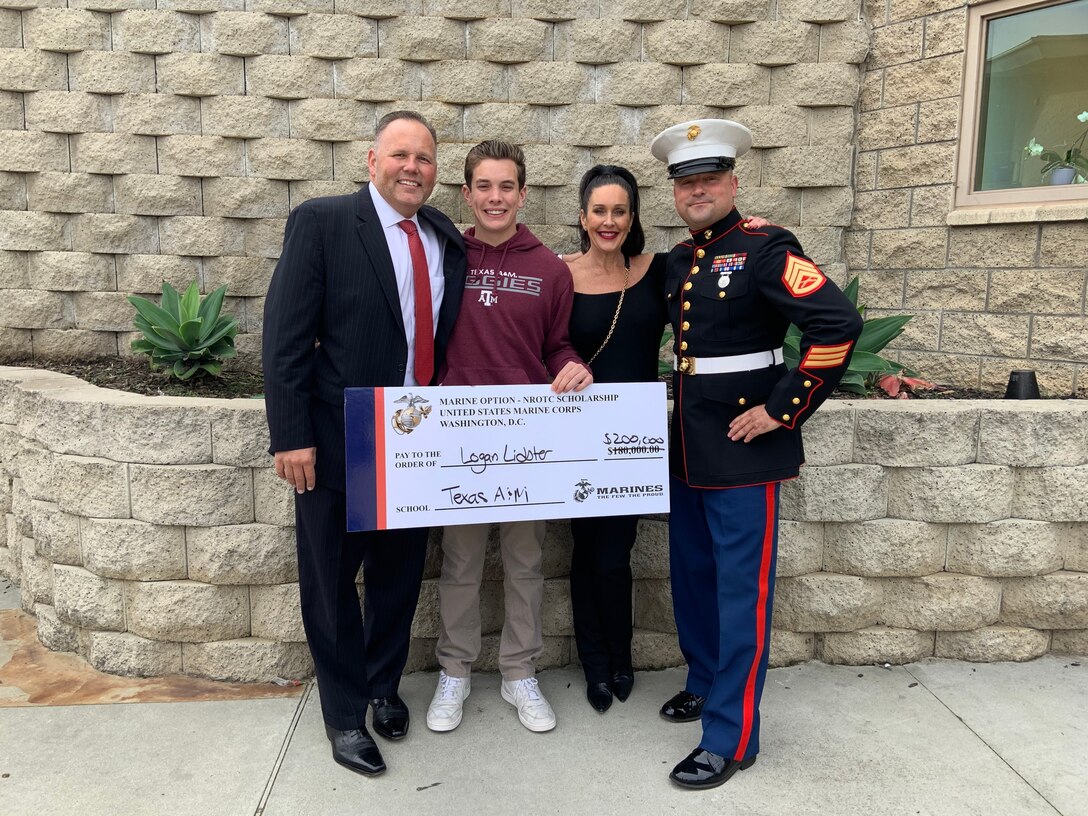 Logan Lidster, his parents, and Staff Sgt. Jacob Louis pose for a photo at Mission Hills High School, March 9, 2020, after Louis presented Lidster with the Naval Officers Training Corps Scholarship. Lidster will attend Texas A&M University, prior to commissioning as a 2nd Lieutenant in the United States Marine Corps.
