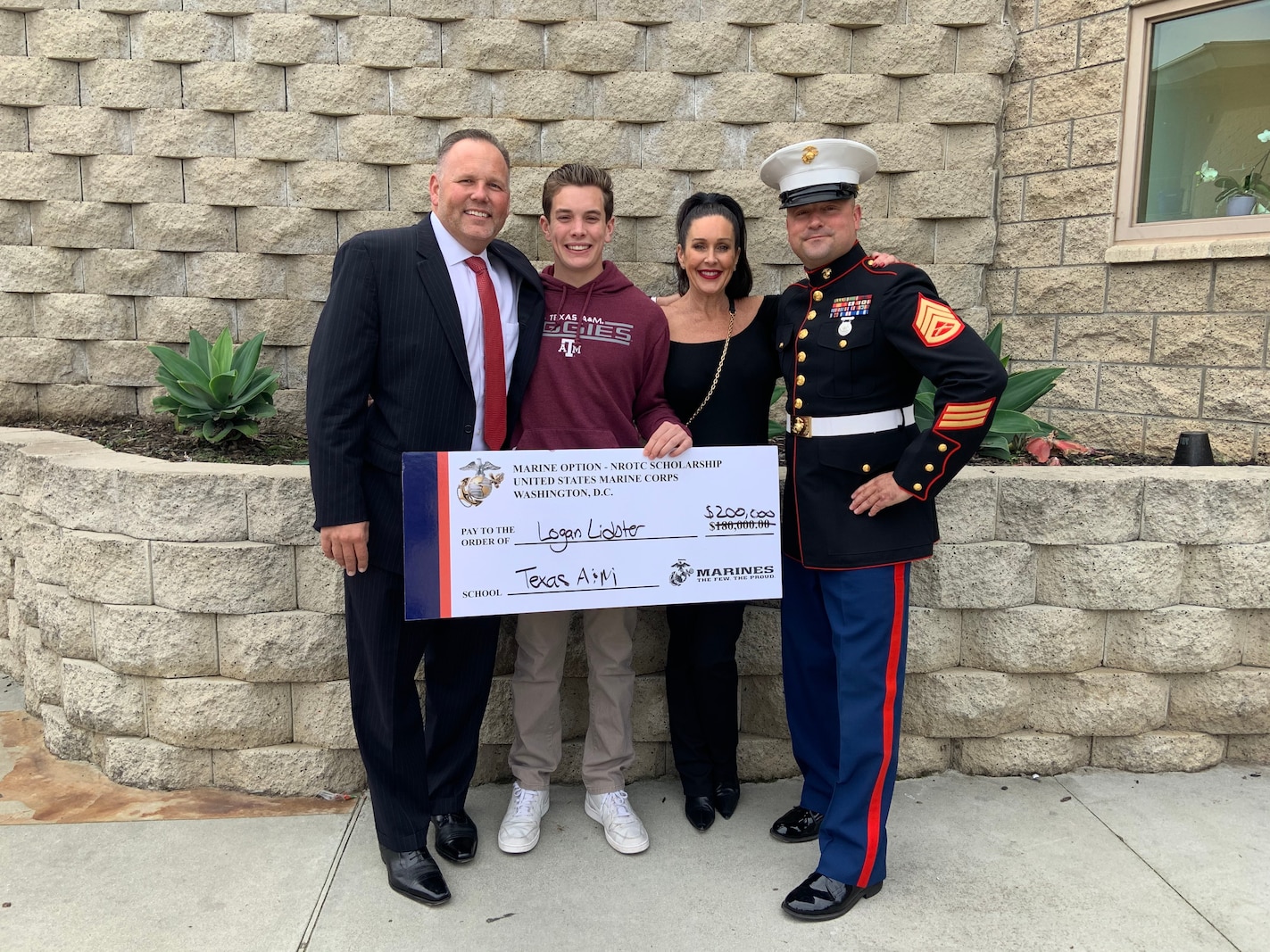 Logan Lidster, his parents, and Staff Sgt. Jacob Louis pose for a photo at Mission Hills High School, March 9, 2020, after Louis presented Lidster with the Naval Officers Training Corps Scholarship. Lidster will attend Texas A&M University, prior to commissioning as a 2nd Lieutenant in the United States Marine Corps.