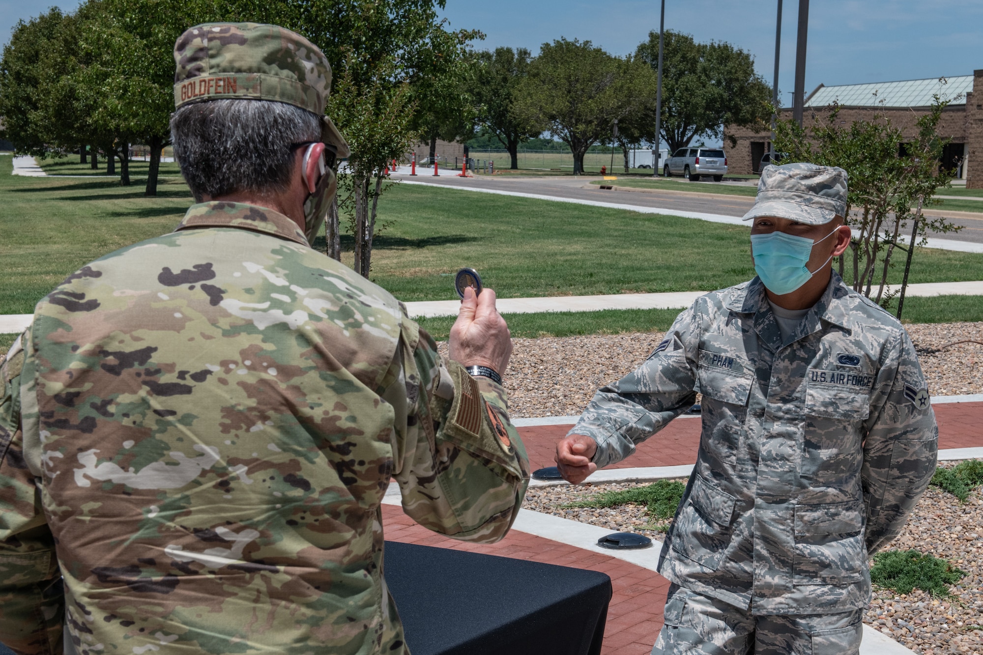 Air Force Chief of Staff Gen. David L. Goldfein coins Airman 1st Class Binh Pham, a radar, airfield and weather systems specialist for the 205th Engineering and Installation Squadron, during a base visit on June 8, 2020, at Will Rogers Air National Guard Base in Oklahoma City. Pham was nominated to receive a coin from Goldfein for his exceptional contributions as a Guardsman serving at the Regional Food Bank of Oklahoma during the state’s response to COVID-19.