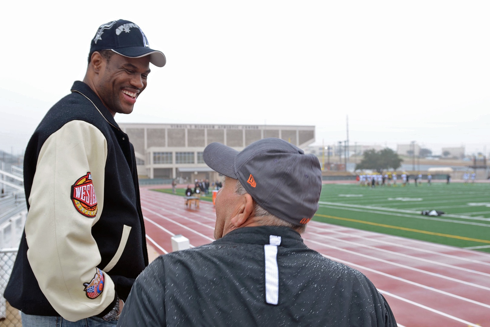 Former San Antonio Spurs center David Robinson speaks with a U.S. Army All-American West Team family member at the Blossom Athletic Center in San Antonio, Dec. 31, 2012.