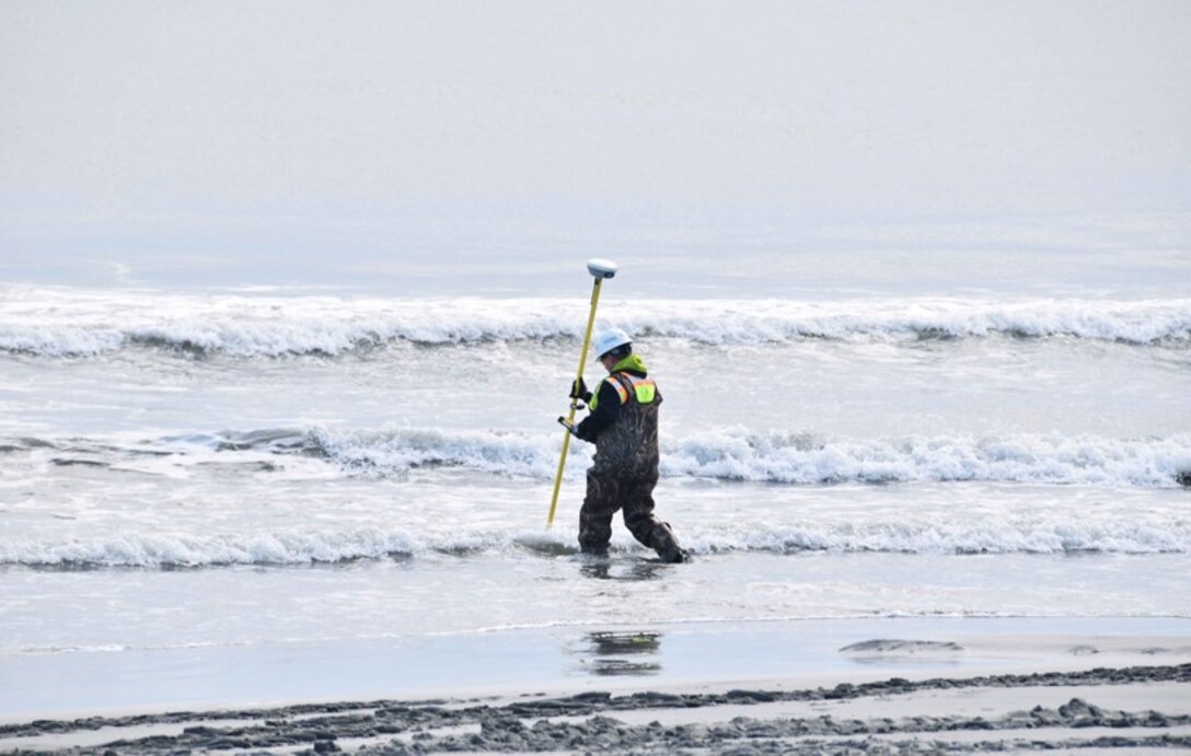 A technician conducts survey of the surf zone during 2017 beachfill operations in Avalon.