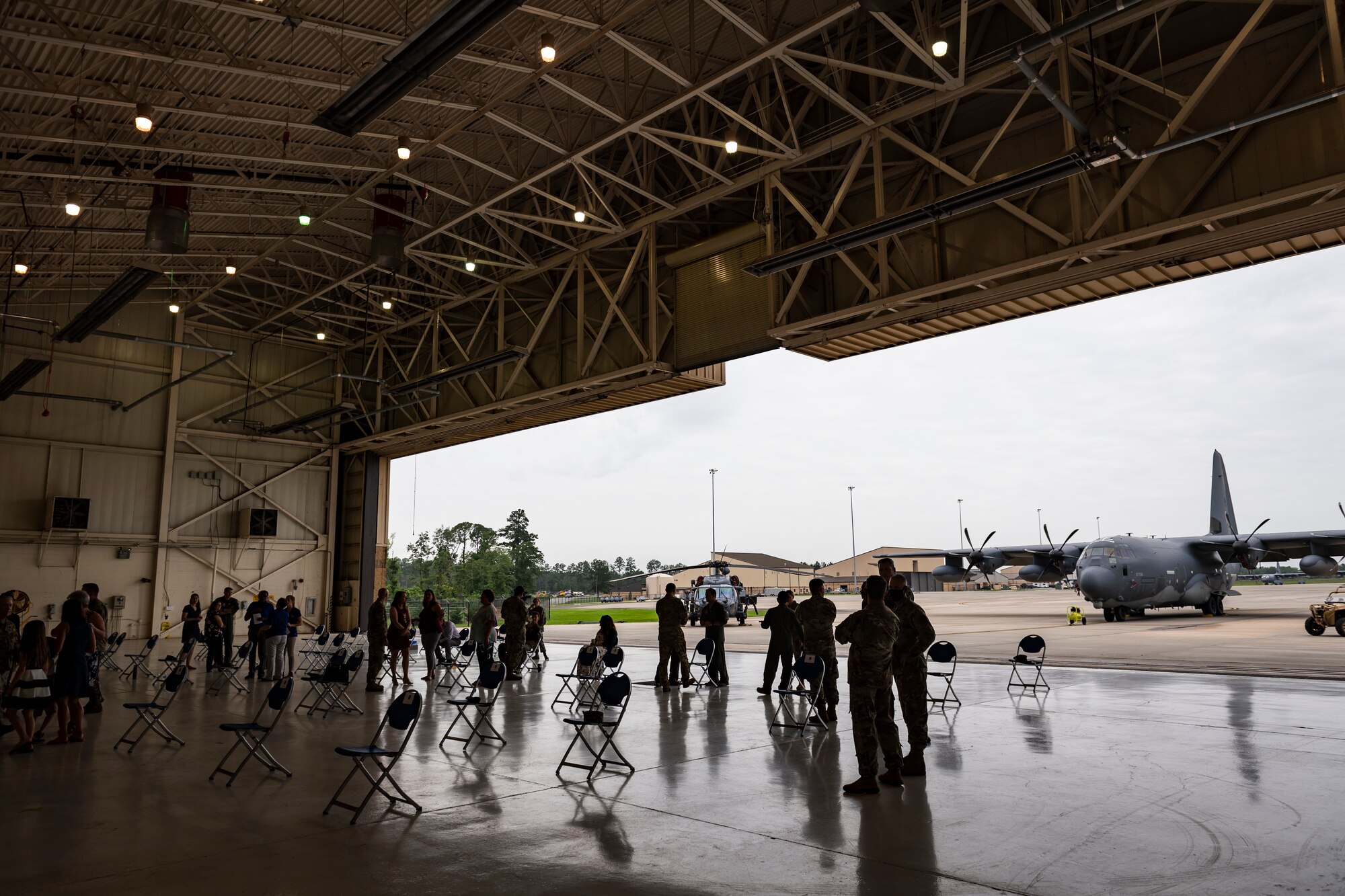 A photo of attendees waiting for a change of command ceremony to begin