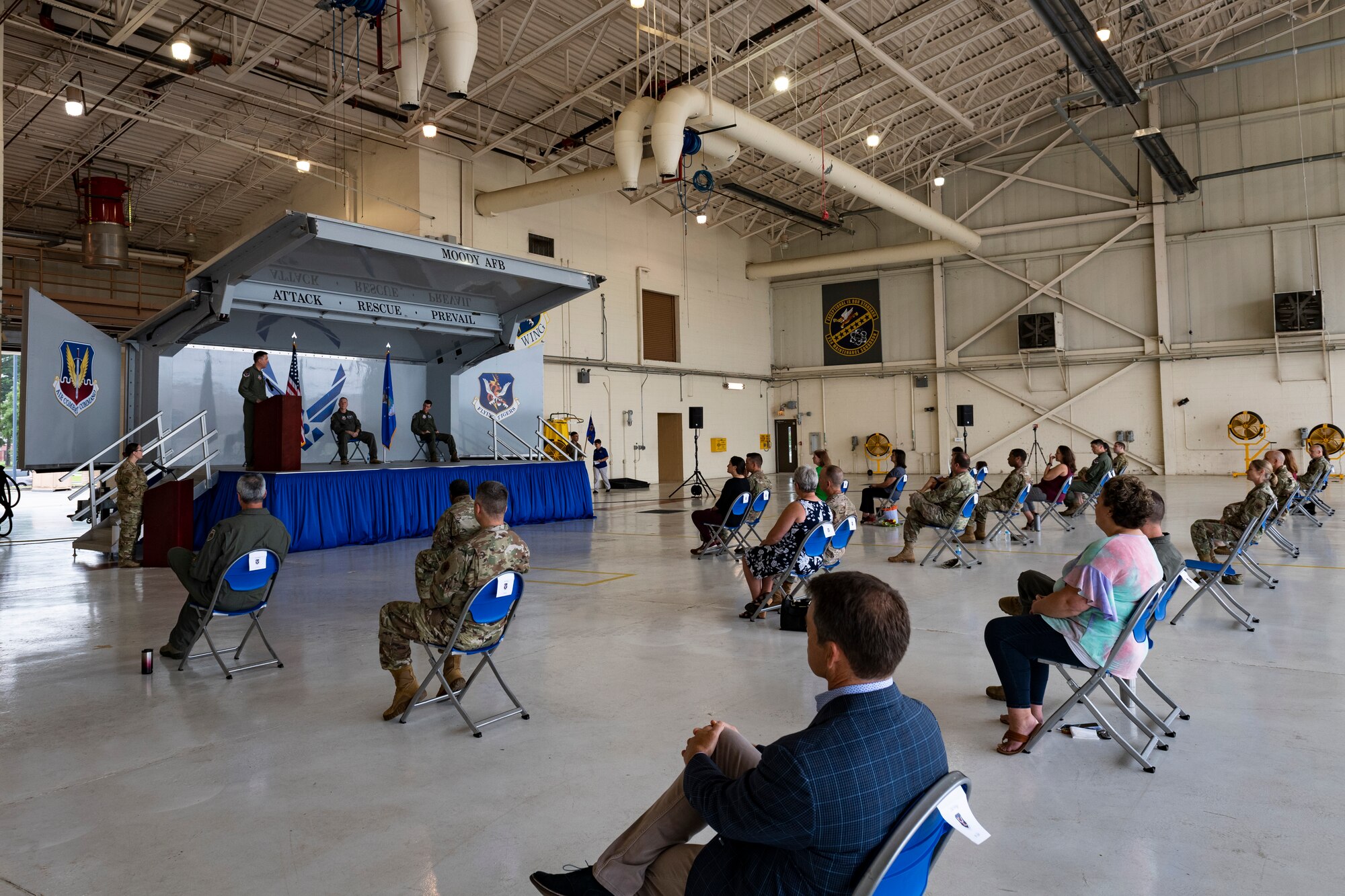 A photo of the 23d Wing commander speaking to the audience of a change of command ceremony