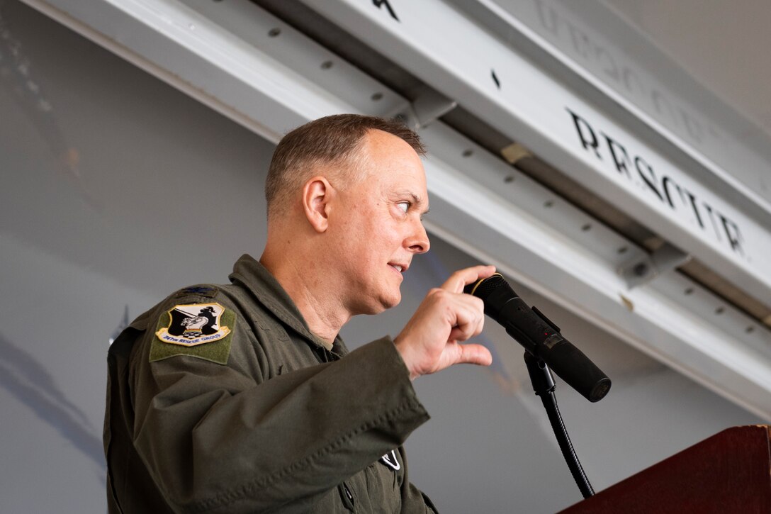A photo of the rescue group commander addressing the attendees of a change of command cermony