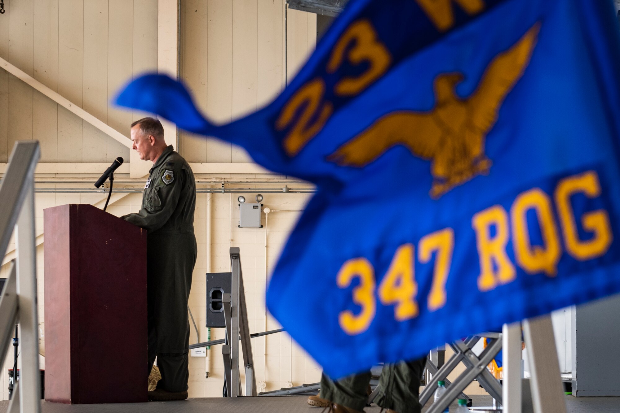 A photo of the rescue group commander addressing attendees of a change of command ceremony