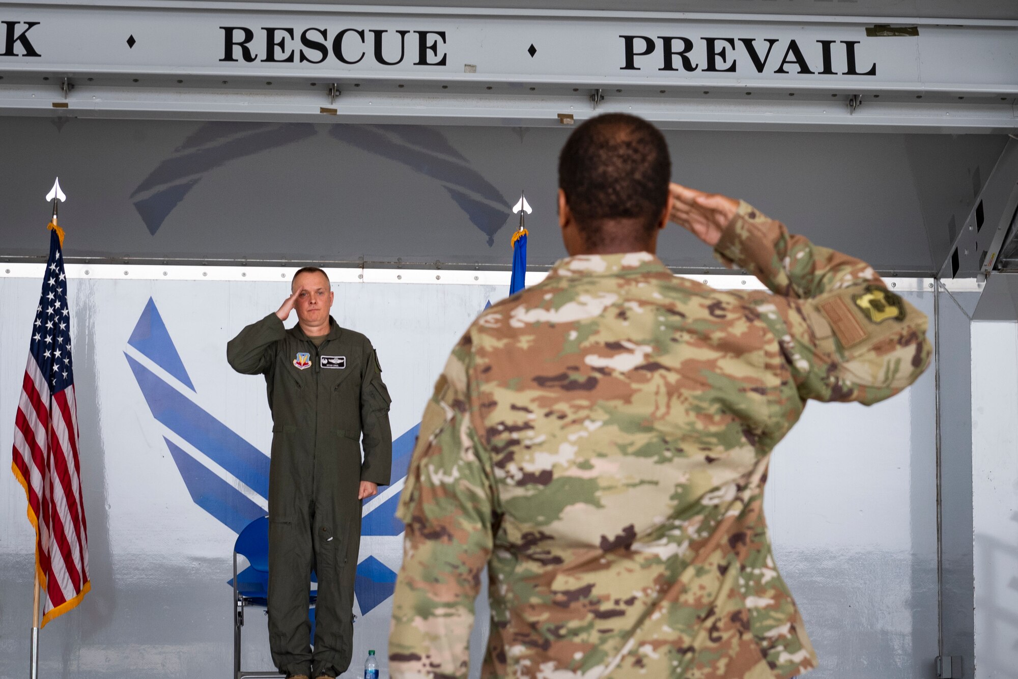 A photo of an Airman saluting the commander of the rescue group