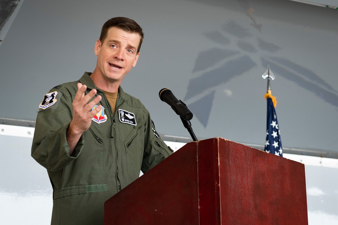 A photo of the commander for the rescue group addressing attendees of the change of command ceremony.