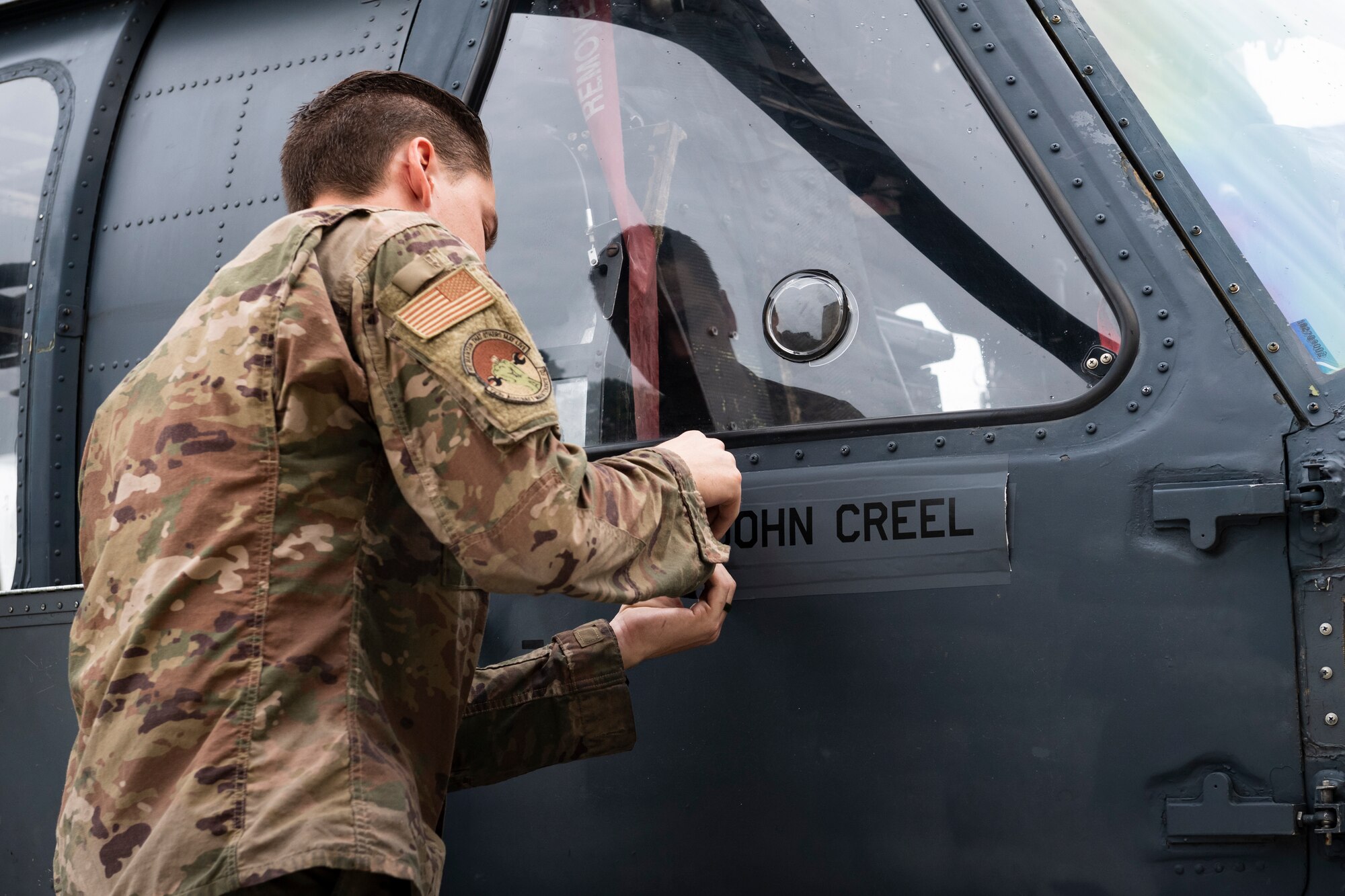 A photo of an Airman renaming the flagship