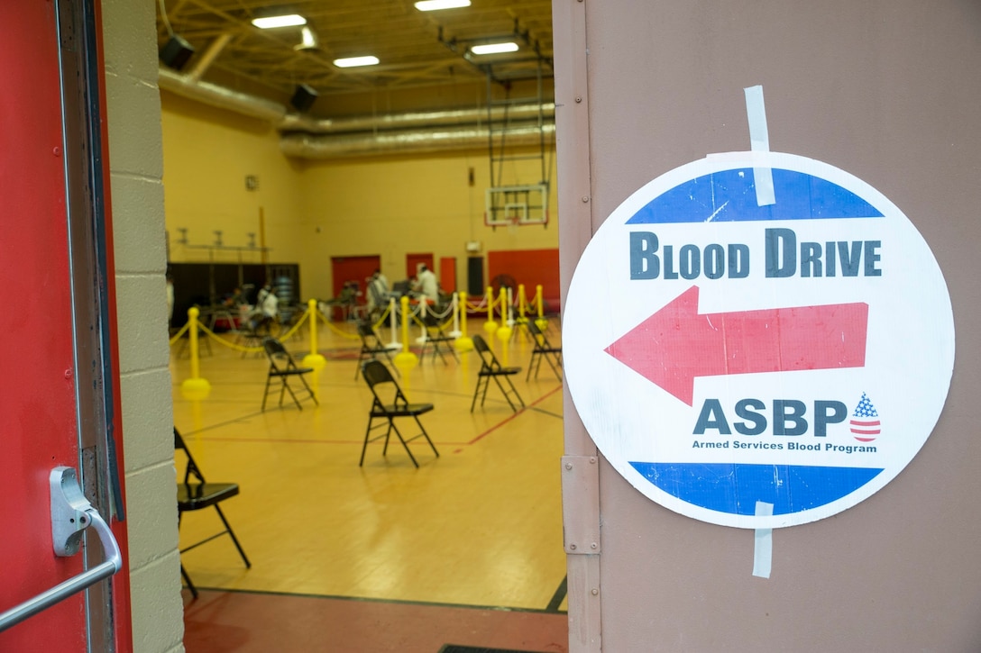 A welcoming signed is posted on the door of the Hopkins Gymnasium during an Armed Services Blood Program (ASBP) blood drive on Camp Elmore, Norfolk, Virginia, May 28.