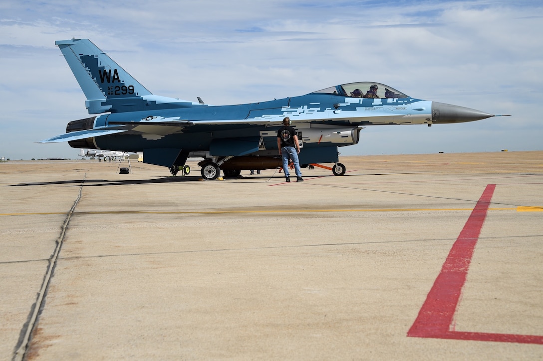 A maintainer and a pilot with the 514th Flight Test Squadron prepare to launch an F-16 Fighting Falcon with a "ghost" paint scheme at Hill Air Force Base, Utah, June 3, 2020. (U.S. Air Force photo by R. Nial Bradshaw)
