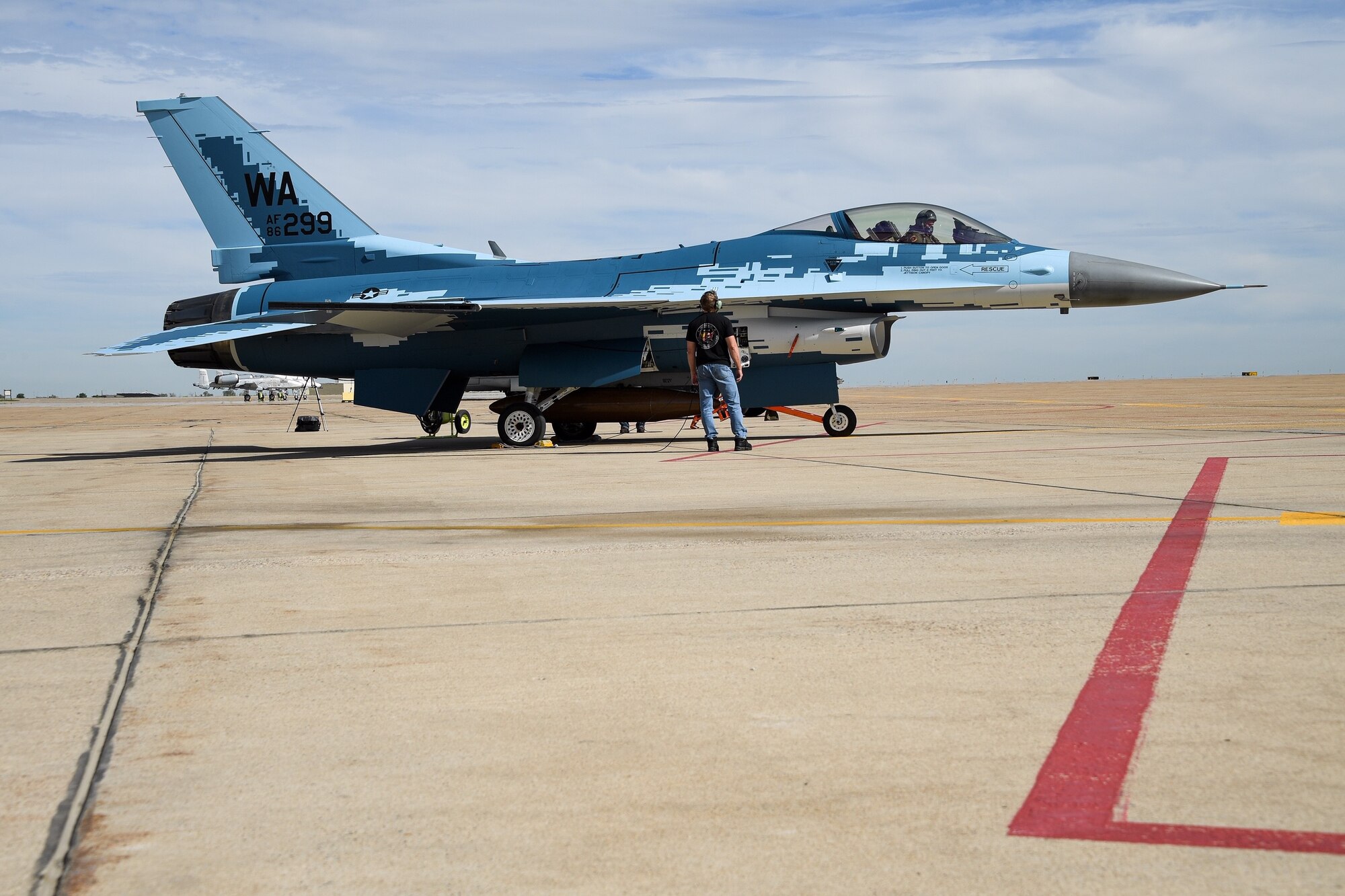 A maintainer and a pilot with the 514th Flight Test Squadron prepare to launch an F-16 Fighting Falcon with a "ghost" paint scheme at Hill Air Force Base, Utah, June 3, 2020. (U.S. Air Force photo by R. Nial Bradshaw)