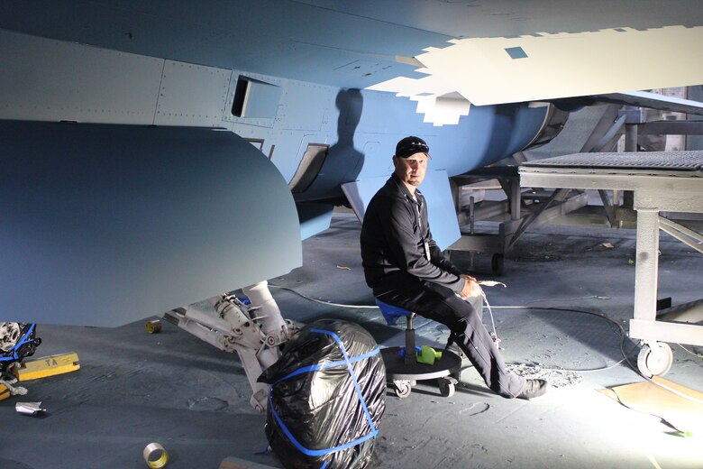 576th Aircraft Maintenance Squadron paint shop technician, Jared Hart inspects an F-16 Fighting Falcon he helped paint with a “ghost” paint scheme at Hill Air Force Base, Utah, May 21, 2020. The paint scheme is intended to replicate an adversary’s fighter jet. United States, allied, and partner-nation aircrews routinely train against accurate and realistic threats including aircraft painted to replicate those pilots might see in aerial combat. (U.S. Air Force photo by Donovan Potter)