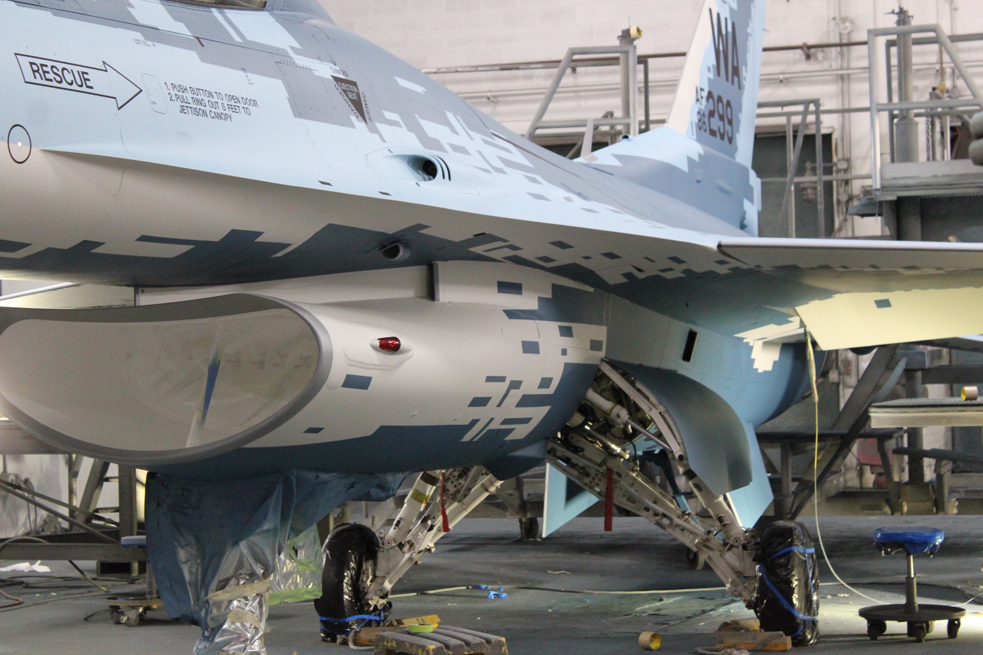 An F-16 Fighting Falcon that 576th Aircraft Maintenance Squadron paint shop technicians painted with a “ghost” paint scheme nears completion at Hill Air Force Base, Utah, May 21, 2020. The paint scheme is intended to replicate an adversary’s fighter jet. United States, allied, and partner-nation aircrews routinely train against accurate and realistic threats including aircraft painted to replicate those pilots might see in aerial combat. (U.S. Air Force photo by Donovan Potter)