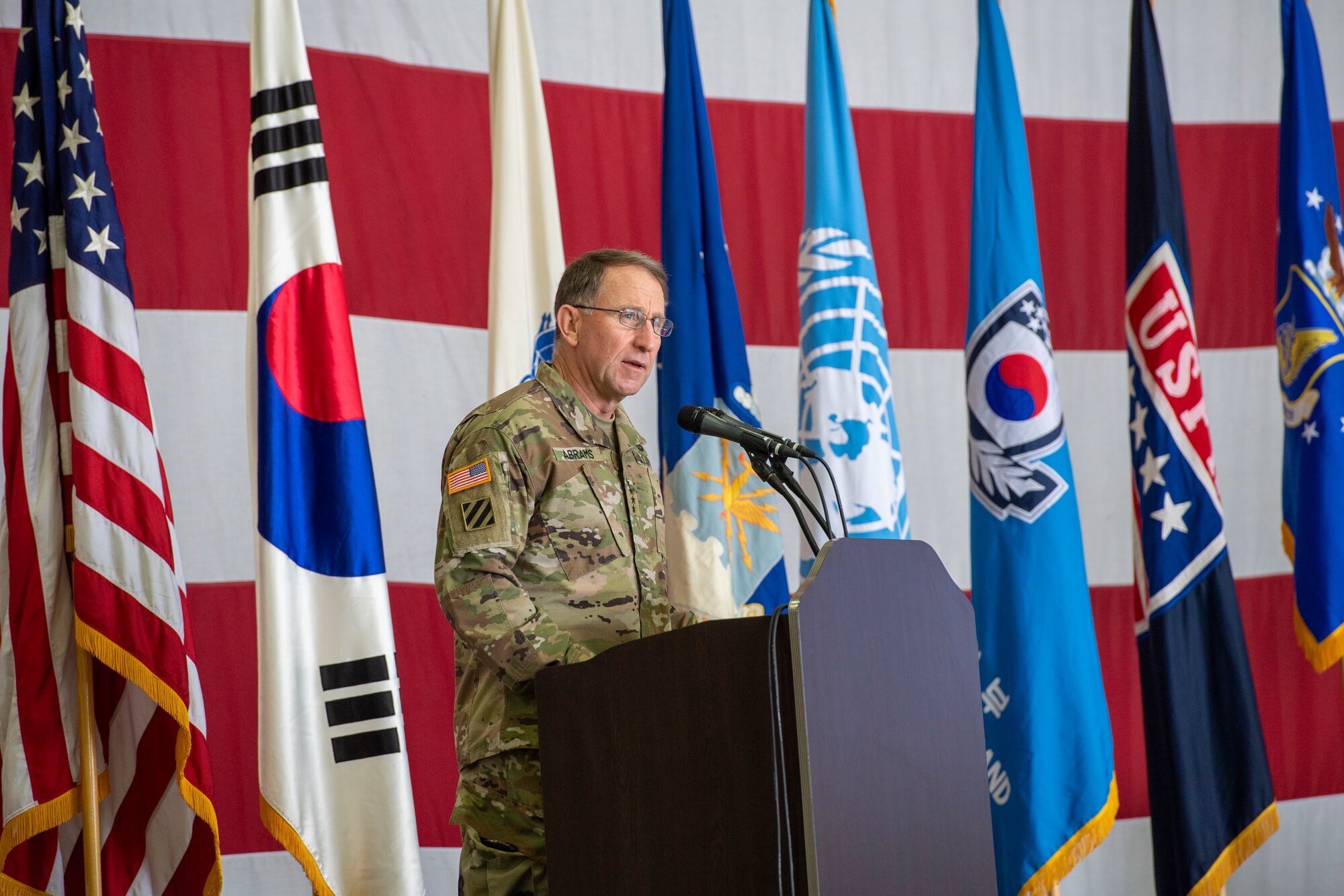 Gen. Robert “Abe” Abrams, Commander, United Nations Command/Combined Forces Command/United States Forces Korea, delivers a speech as the presiding official over the change of command of the Air Component Command and the change of responsibility for the deputy commander of USFK at Osan Air Base, ROK, June 12, 2020. Abrams spoke on the outbound party, Lt. Gen. Kenneth S. Wilsbach, and the inbound party, Lt. Gen. Scott L. Pleus. (U.S. Air Force photo by Senior Airman Darien Perez)