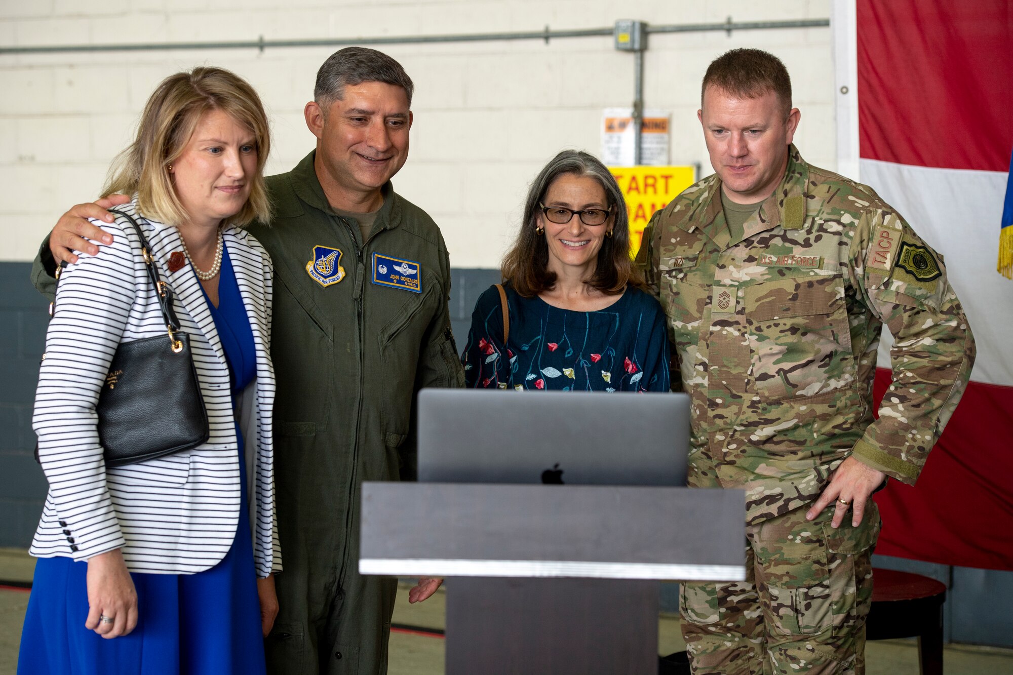 Nicole Gonzales, Col. John Gonzales, 51st Fighter Wing commander,  Gina Vizi and Chief Master Sgt. Adam Vizi, 51st FW command chief, greet Lt. Gen. Scott L. Pleus, Seventh Air Force commander, virtually at Osan Air Base, ROK, June 12, 2020. Pleus was in quarantine due to COVID-19 mitigation measures. (U.S. Air Force photo by Senior Airman Darien Perez)