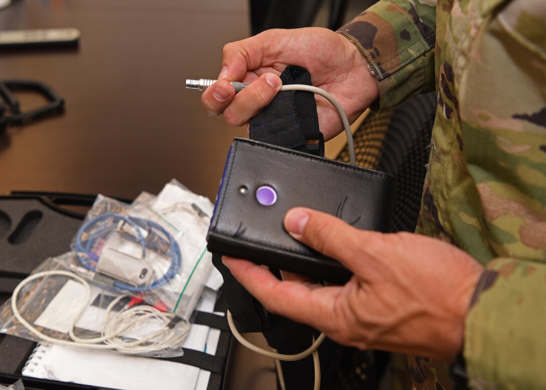 U.S. Air Force Maj. John Doleski, 17th Medical Group mental health clinic flight commander, unpacks parts to a biofeedback medical device in the mental health clinic on Goodfellow Air Force Base, Texas, June 5, 2020. The equipment was used to record the patient's heart rate while monitoring the biological response to an introduced stressor. (U.S. Air Force photo by Airman 1st Class Abbey Rieves)