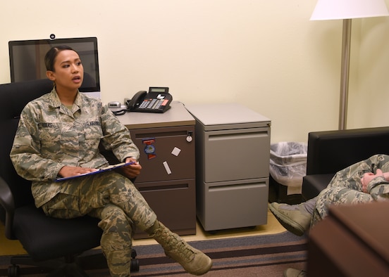 U.S. Air Force Airman 1st Class Alyssa Roxas, 17th Medical Group mental health technician, performs a patient evaluation, with a social distance of six feet away, in the mental health clinic on Goodfellow Air Force Base, Texas, June 5, 2020.  Roxas was trained to schedule new-patient appointments, provide evaluations, administer crisis intervention, perform pre-deployment psychological testing, and address safety concerns. (U.S. Air For photo by Airman 1st Class Abbey Rieves)