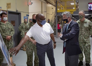 Mid-Atlantic Regional Maintenance Center (MARMC) Production Director Derrick Mitchell discusses a hub replacement job with Secretary of the Navy Kenneth Braithwaite during a tour of MARMC’s Production Facility.