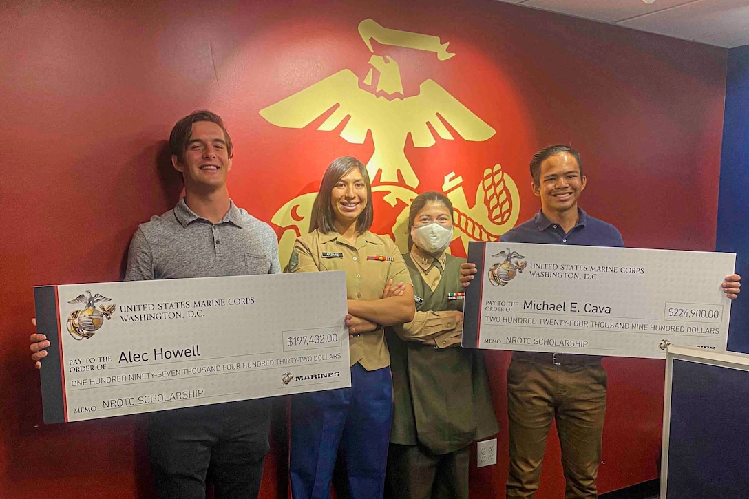 U.S. Marine Corps Staff Sgt. Maria Arzata, canvassing recruiter with Recruiting Station San Diego, and Capt. Katie Sliwoski, executive officer of Recruiting Station San Diego, present Alec Howell and Michael Cava the Naval Reserve Officers Training Corps scholarship in San Diego, Calif. on May 29, 2020. Howell and Cava graduated from Torrey Pines High School, applied, and won the scholarship together.