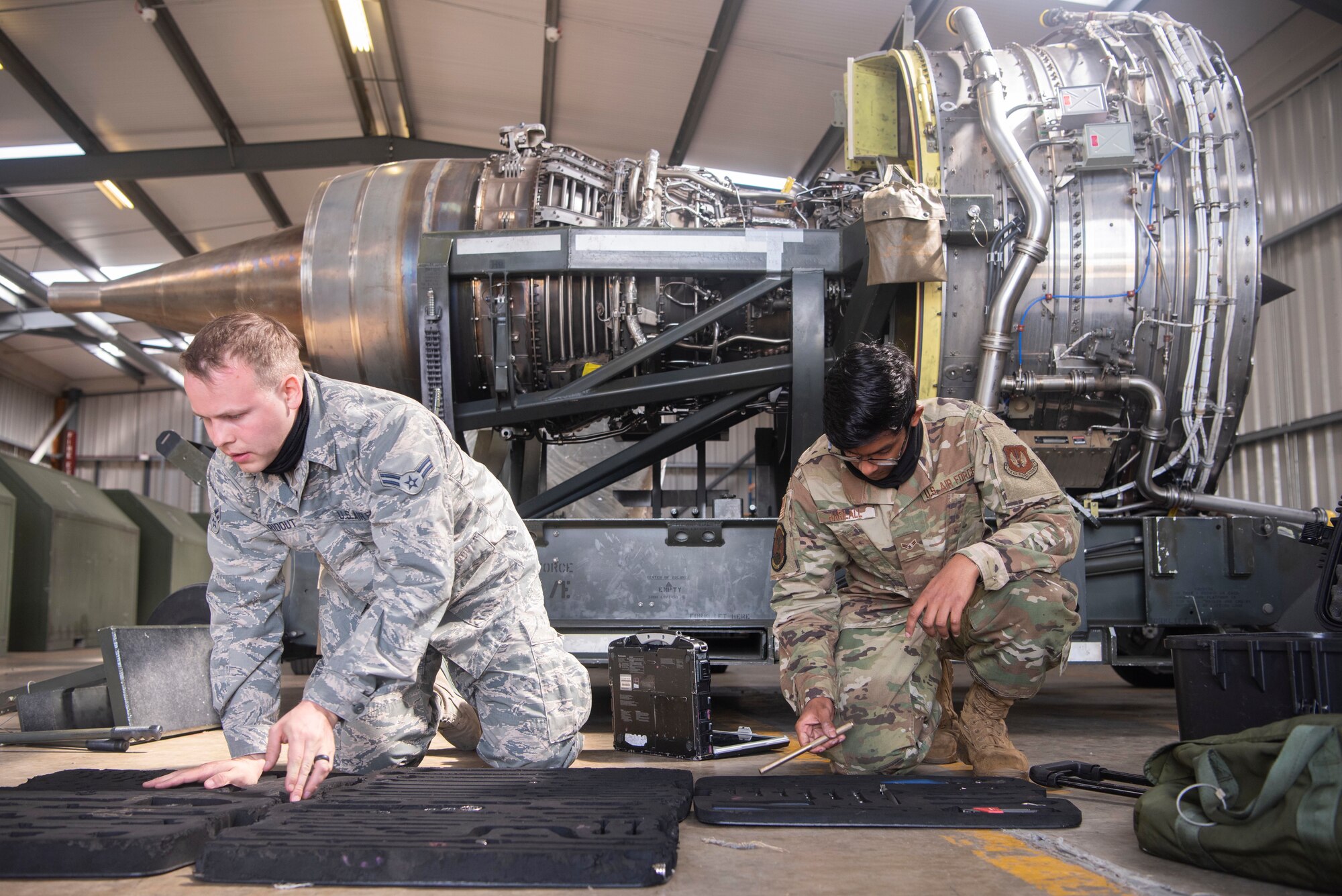 Airman 1st Class Eric Ridout and Airman 1st Class Rajendra Harilall, 100th Aircraft Maintenance Squadron aerospace propulsion journeymen, conduct a tool check at RAF Mildenhall, England, June 9, 2020. The tool check is accomplished to confirm all equipment is accounted for and no foreign object debris is left in the engine. (U.S. Air Force photo by Airman 1st Class Joseph Barron)