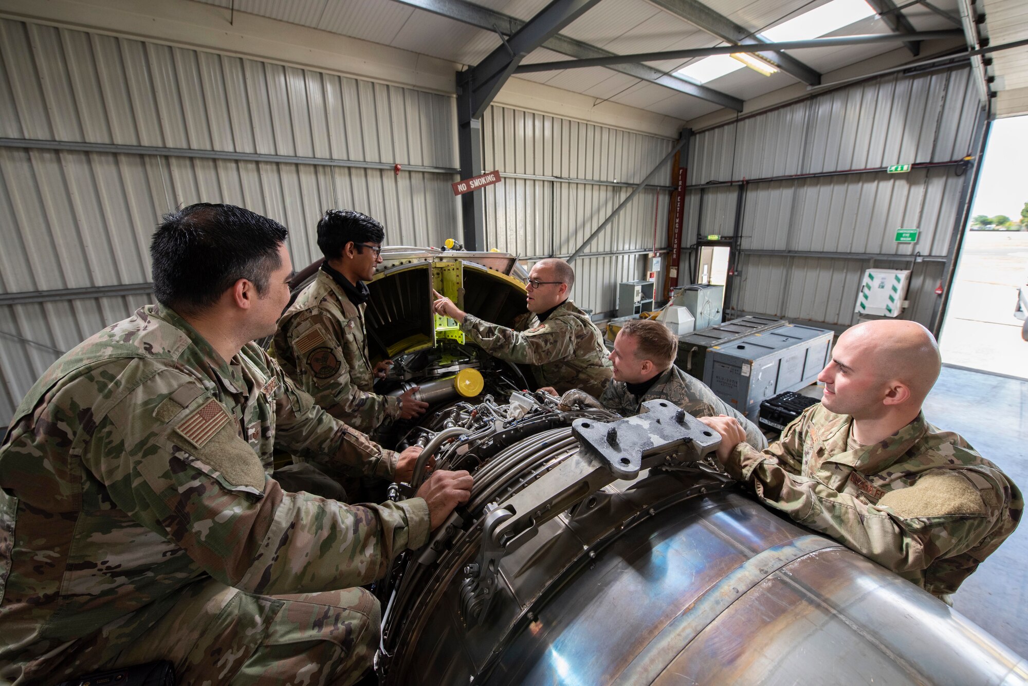 Maintainers of the 100th Aircraft Maintenance Squadron Jet Shop discuss maintenance practices at RAF Mildenhall, England, June 9, 2020. Troubleshooting ability and knowing how the engine works is integral to successful maintenance. (U.S. Air Force photo by Airman 1st Class Joseph Barron)