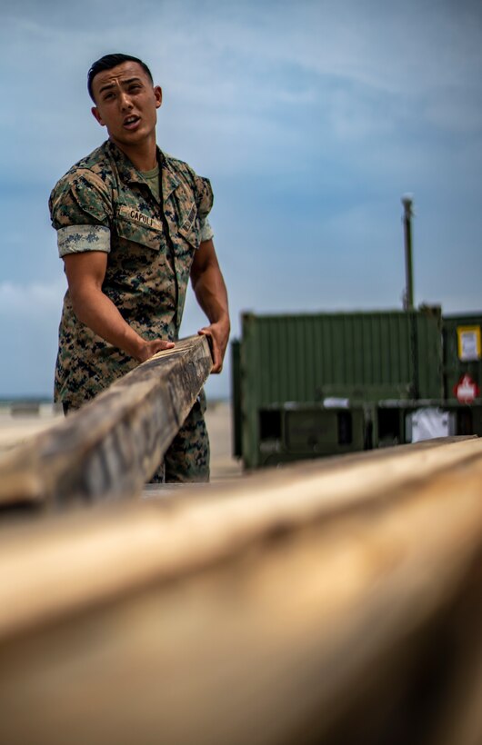 Cpl. Benjamin Capuli, an embarkation clerk with Special Purpose Marine Air-Ground Task Force - Southern Command, unloads gear during a strategic mobility exercise at Marine Corps Air Station Cherry Point, North Carolina, May 28, 2020. The SPMAGTF-SC Marines and Sailors conducted a MOBEX to validate the unit’s ability to rapidly and effectively deploy to Latin America and the Caribbean for crisis response efforts. The MOBEX will help the task force identify any resource shortfalls required to deploy from Camp Lejeune, North Carolina, to U.S. Southern Command’s area of operations, and give the service members an opportunity to demonstrate their ability to rapidly deploy at a moment’s notice. Capuli is native of Tacoma, Washington. (U.S. Marine Corps photo by Sgt. Andy O. Martinez)