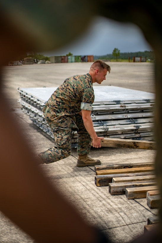 Lance Cpl. Alec Pomeroy, an embarkation clerk with Special Purpose Marine Air-Ground Task Force - Southern Command, unloads gear during a strategic mobility exercise at Marine Corps Air Station Cherry Point, North Carolina, May 28, 2020. SPMAGTF-SC Marines and Sailors conducted a MOBEX to validate the unit’s ability to rapidly and effectively deploy to Latin America and the Caribbean for crisis response efforts. The MOBEX will help the task force identify any resource shortfalls required to deploy from Camp Lejeune, North Carolina, to U.S. Southern Command’s area of operations, and give the service members an opportunity to demonstrate their ability to rapidly deploy at a moment’s notice. Pomeroy is native of a Duvall, Washington. (U.S. Marine Corps photo by Sgt. Andy O. Martinez)