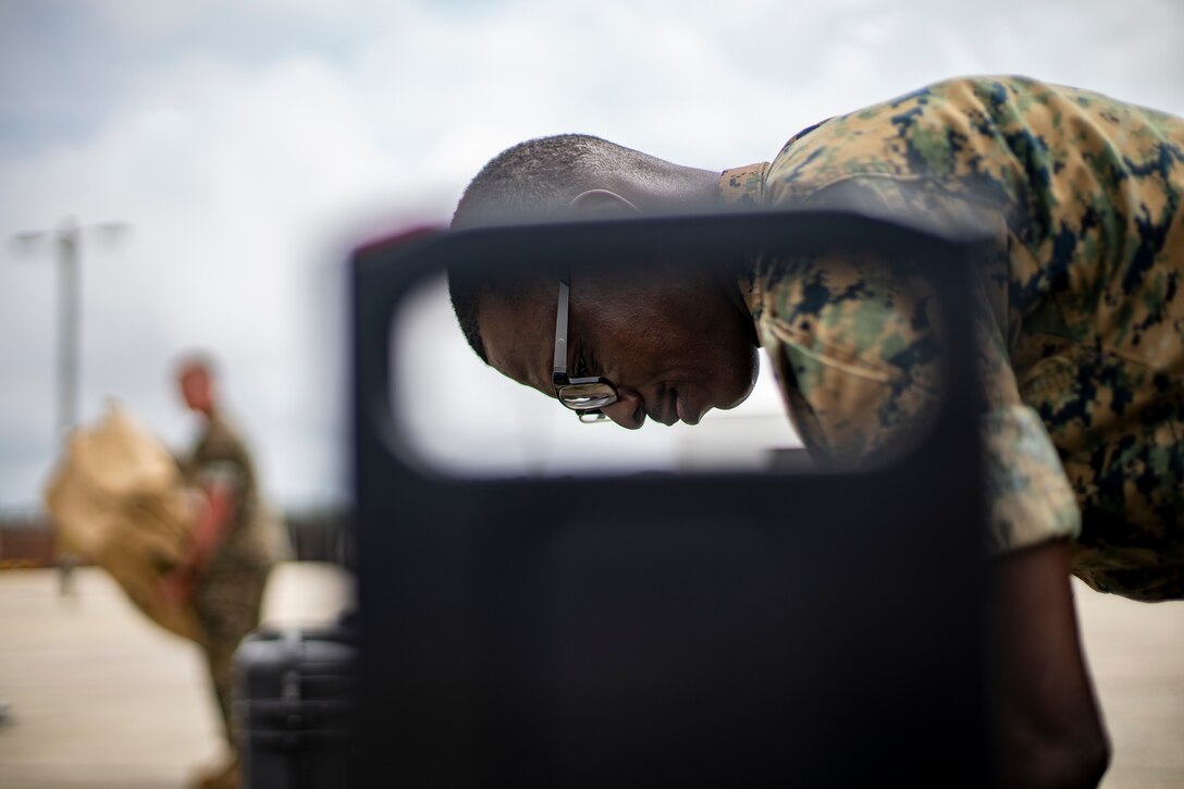 Navy Petty Officer 2nd Class Olayinka Awoku, a hospital corpsman with Special Purpose Marine Air-Ground Task Force - Southern Command, unloads gear during a strategic mobility exercise at Marine Corps Air Station Cherry Point, North Carolina, May 28, 2020. SPMAGTF-SC Marines and Sailors conducted a MOBEX to validate the unit’s ability to rapidly and effectively deploy to Latin America and the Caribbean for crisis response efforts. The MOBEX will help the task force identify any resource shortfalls required to deploy from Camp Lejeune, North Carolina, to U.S. Southern Command’s area of operations, and give the service members an opportunity to demonstrate their ability to rapidly deploy at a moment’s notice. Awoku is a native of Jacksonville, Florida. (U.S. Marine Corps photo by Sgt. Andy O. Martinez)