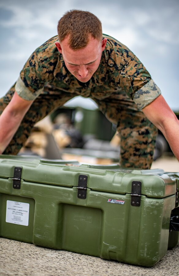 Staff Sgt. William Hasting, an embarkation chief with Special Purpose Marine Air-Ground Task Force - Southern Command, unloads gear during a strategic mobility exercise at Marine Corps Air Station Cherry Point, North Carolina, May 28, 2020. SPMAGTF-SC Marines and Sailors conducted a MOBEX to validate the unit’s ability to rapidly and effectively deploy to Latin America and the Caribbean for crisis response efforts. The MOBEX will help the task force identify any resource shortfalls required to deploy from Camp Lejeune, North Carolina, to U.S. Southern Command’s area of operations, and give the service members an opportunity to demonstrate their ability to rapidly deploy at a moment’s notice. Hasting is a native of Kansas City, Missouri. (U.S. Marine Corps photo by Sgt. Andy O. Martinez)