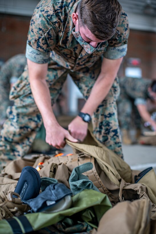 Navy Petty Officer 1st Class Paul Burden, a hospital corpsman with Special Purpose Marine Air-Ground Task Force - Southern Command, unpacks his gear for inspection during a strategic mobility exercise at Marine Corps Air Station Cherry Point, North Carolina, May 29, 2020. SPMAGTF-SC Marines and Sailors conducted a MOBEX to validate the unit’s ability to rapidly and effectively deploy to Latin America and the Caribbean for crisis response efforts. The MOBEX will help the task force identify any resource shortfalls required to deploy from Camp Lejeune, North Carolina, to U.S. Southern Command’s area of operations, and give the service members an opportunity to demonstrate their ability to rapidly deploy at a moment’s notice. Burden is a native of Pearl Harbor, Hawaii. (U.S. Marine Corps photo by Sgt. Andy O. Martinez)