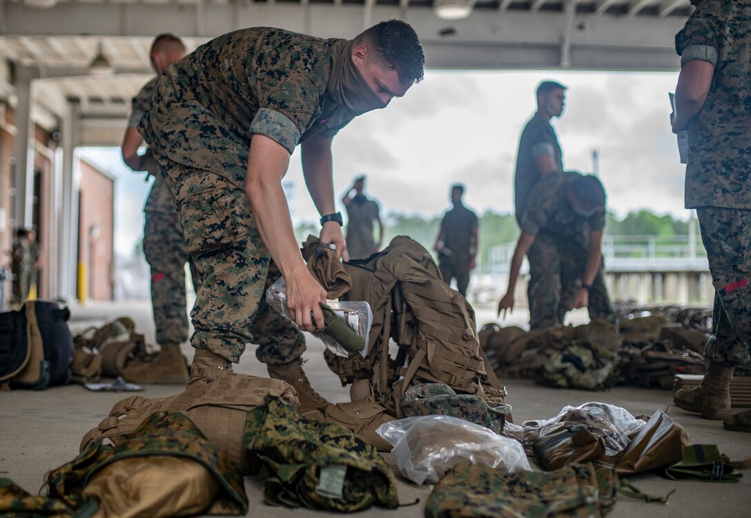 Staff Sgt. Tyler Brookbank, a combat engineer with Special Purpose Marine Air-Ground Task Force - Southern Command, unpacks his gear for inspection during a strategic mobility exercise at Marine Corps Air Station Cherry Point, North Carolina, May 29, 2020. SPMAGTF-SC Marines and Sailors conducted a MOBEX to validate the unit’s ability to rapidly and effectively deploy to Latin America and the Caribbean for crisis response efforts. The MOBEX will help the task force identify any resource shortfalls required to deploy from Camp Lejeune, North Carolina, to U.S. Southern Command’s area of operations, and give the service members an opportunity to demonstrate their ability to rapidly deploy at a moment’s notice. Brookbank is a native of Roseburg, Oregon. (U.S. Marine Corps photo by Sgt. Andy O. Martinez)